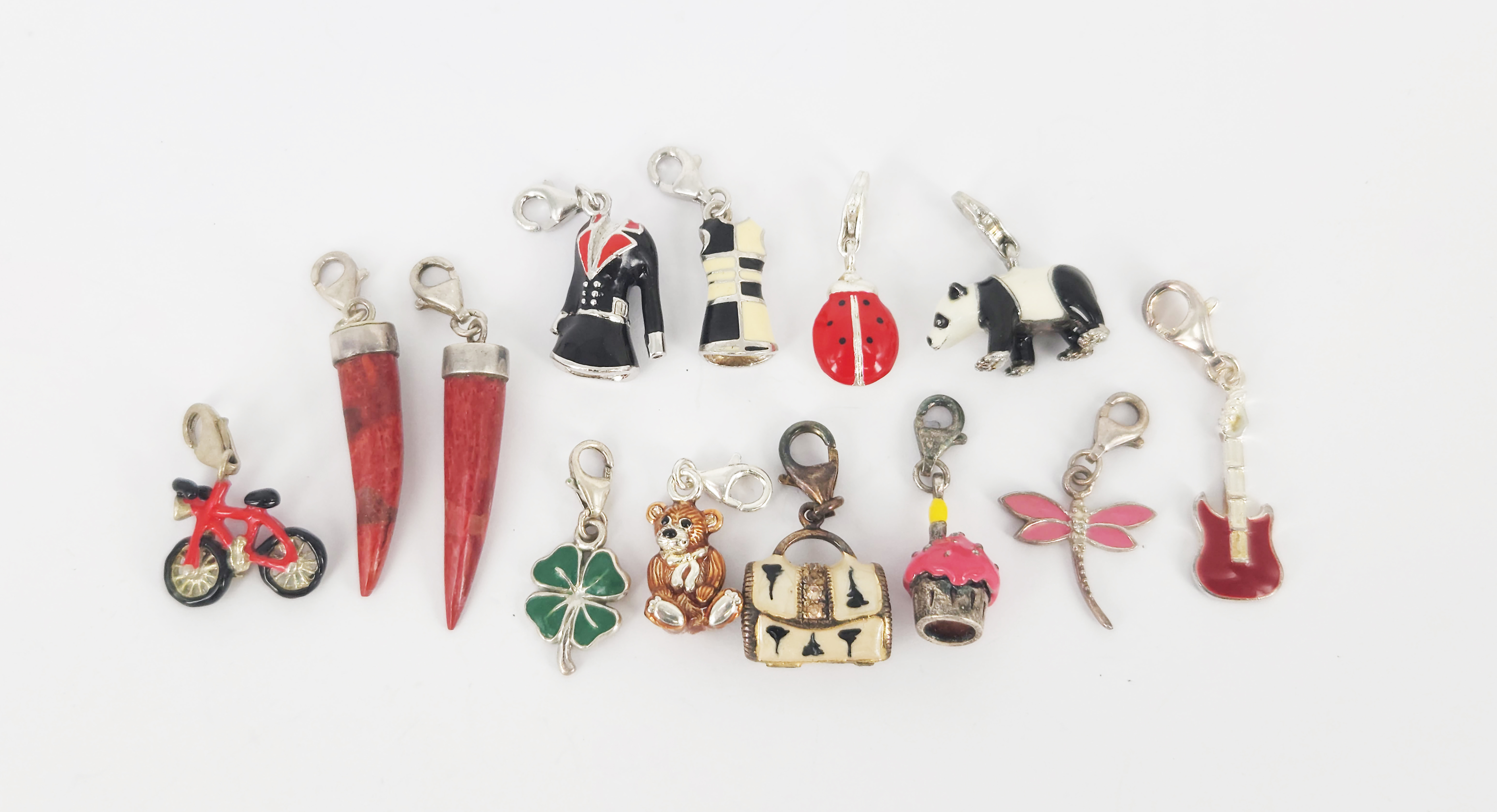 445 · A QUANTITY OF MOSTLY SILVER AND ENAMEL CHARMS