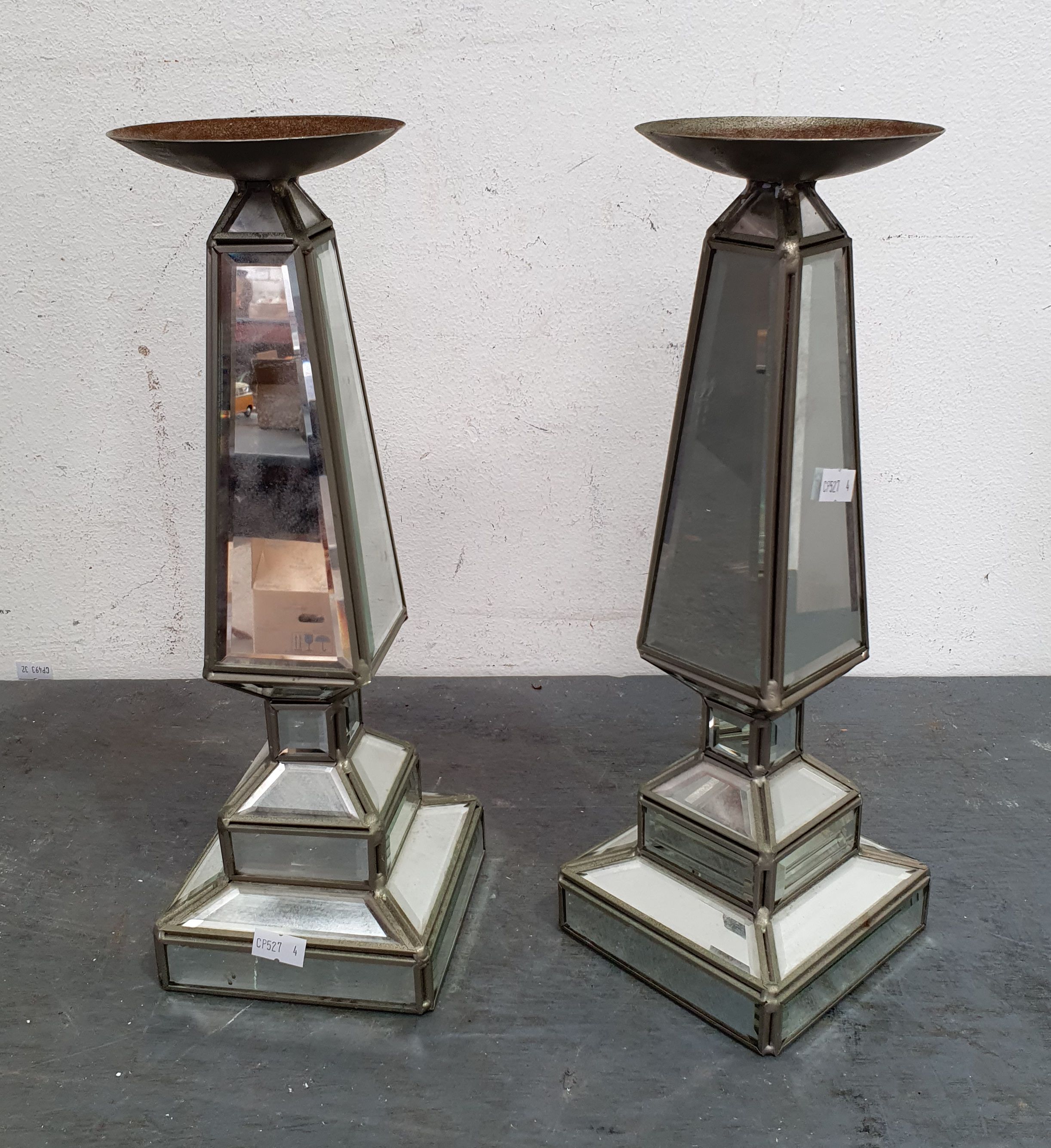 A PAIR OF MIRROR BASED CANDLE HOLDERS
