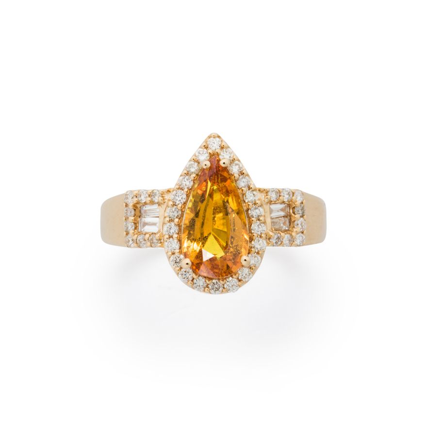 A yellow sapphire, diamond and fourteen karat gold ring