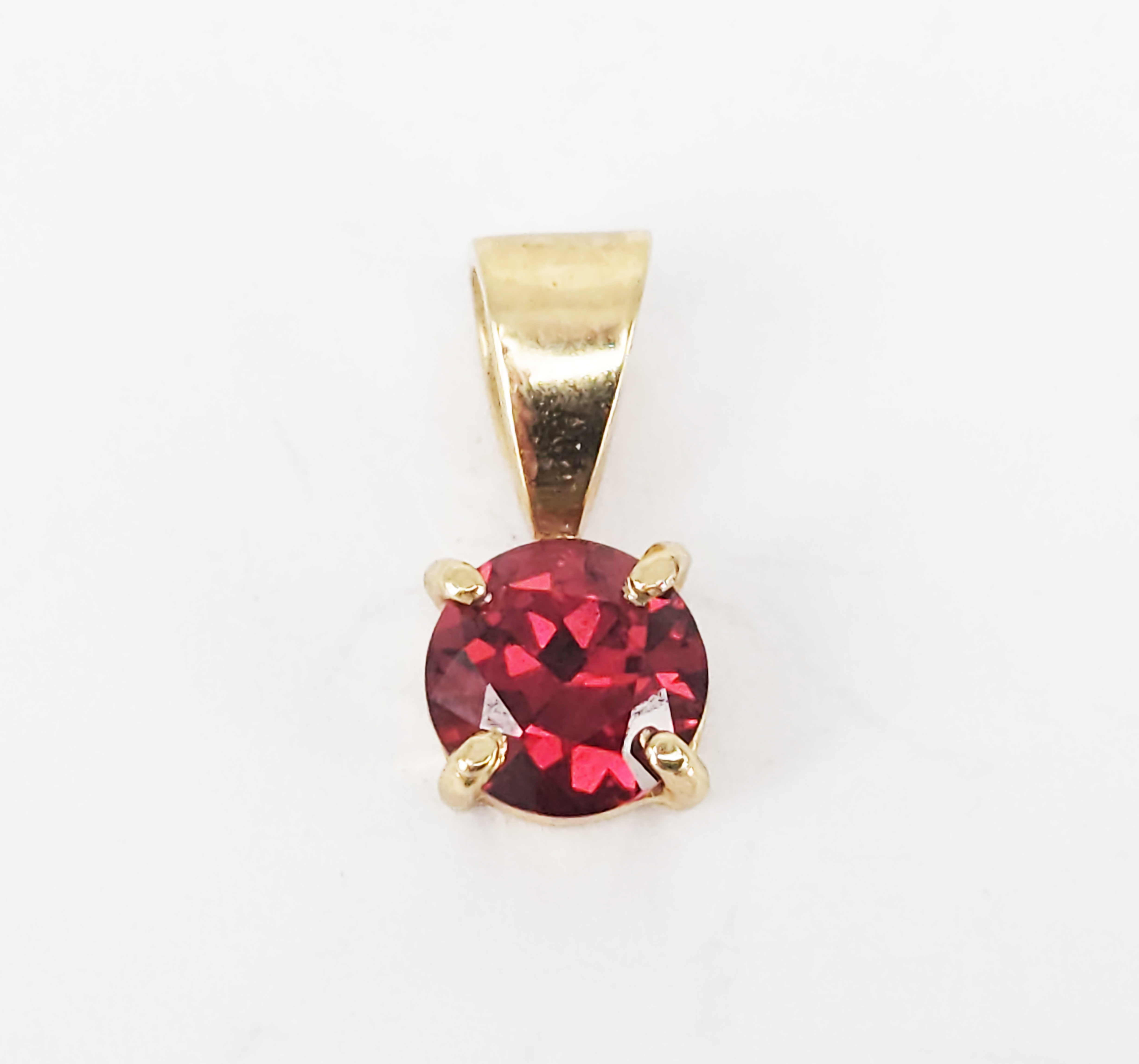 336 · A 9ct YELLOW GOLD GARNET PENDANT