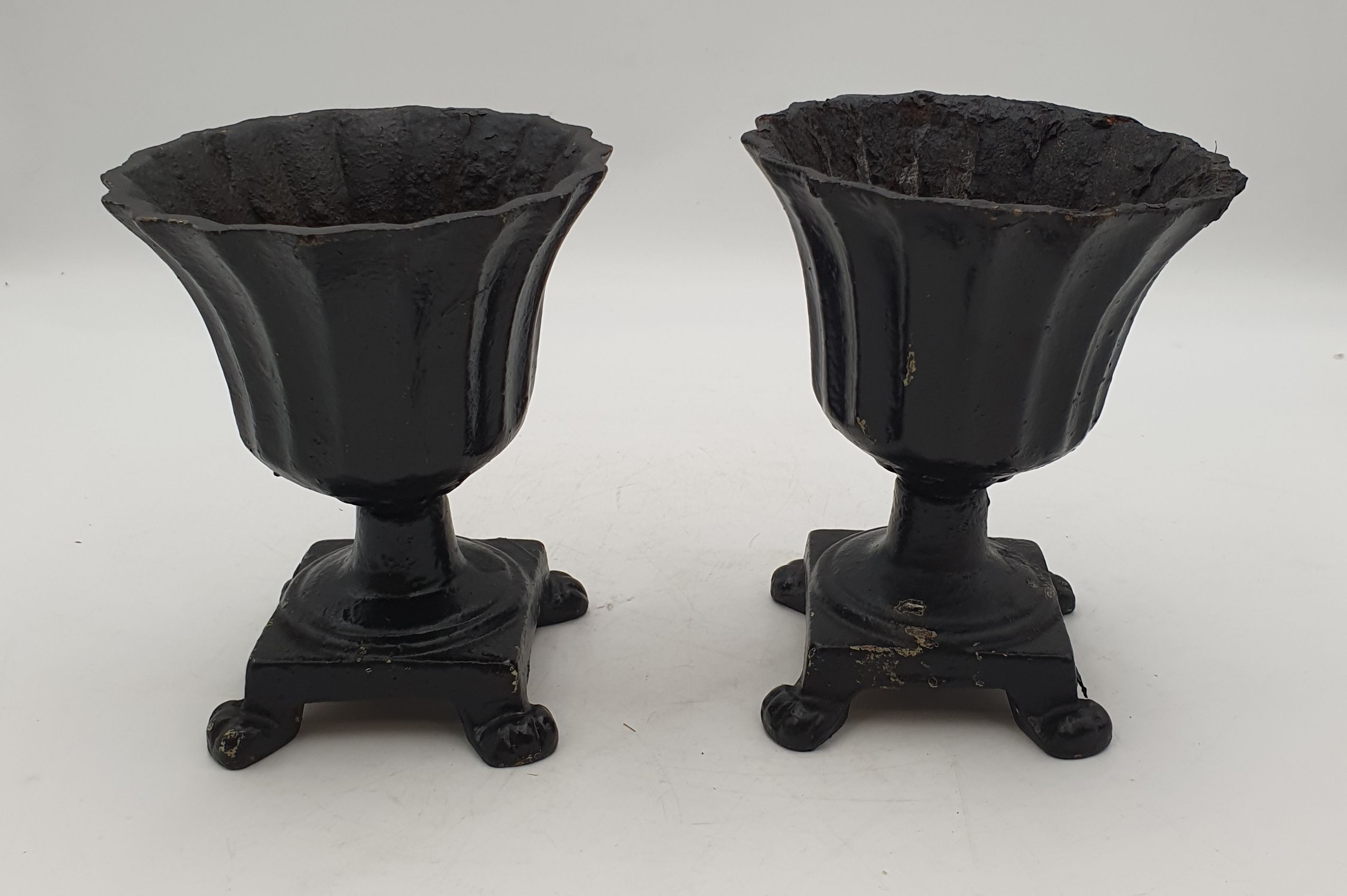 A PAIR OF EARLY 20TH CENTURY BLACK PAINTED IRON URNS