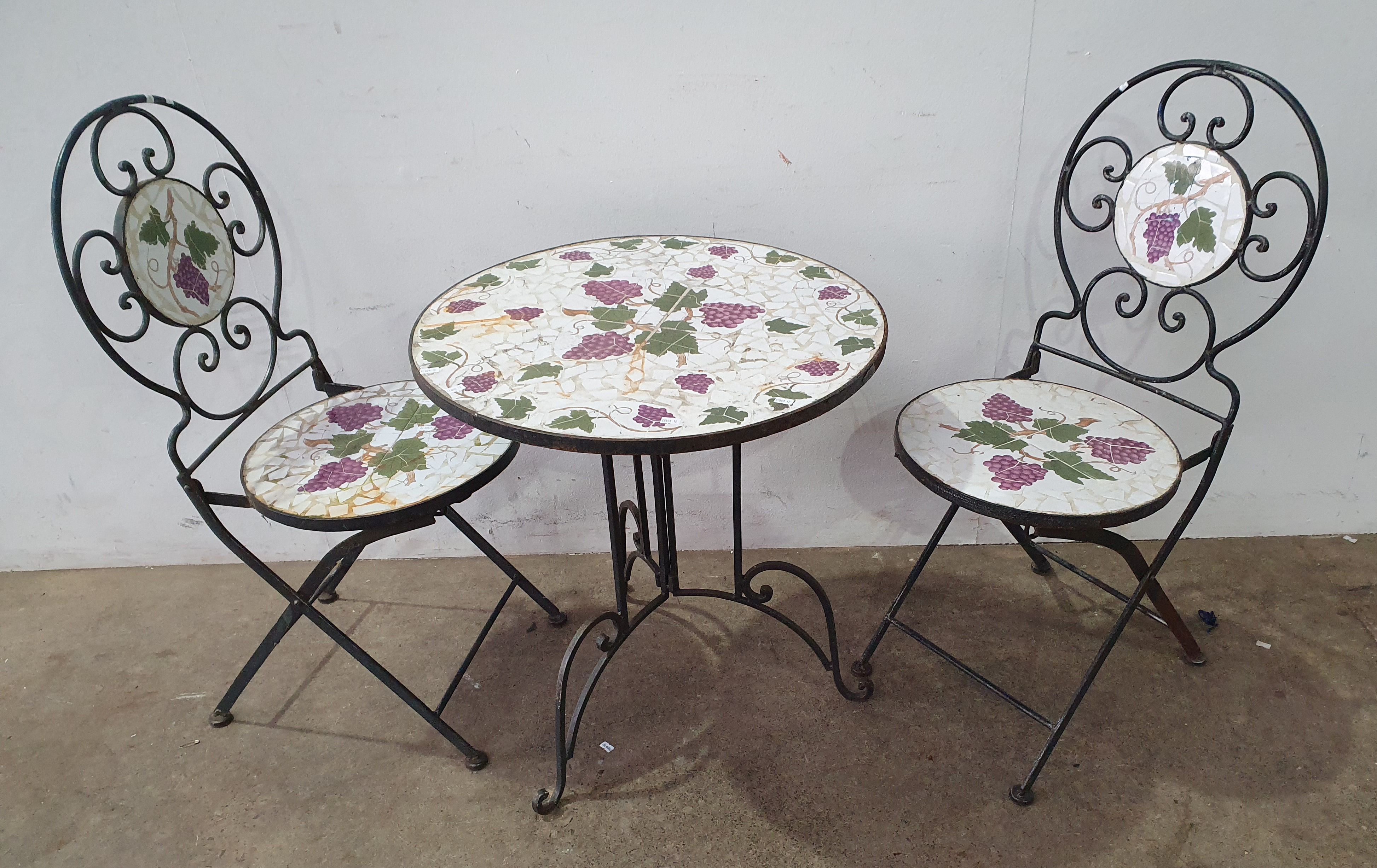 A Three Piece Tile Top Table And Chairs
