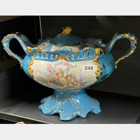 A continental porcelain centre piece and cover, W. 44cm H. 26cm.