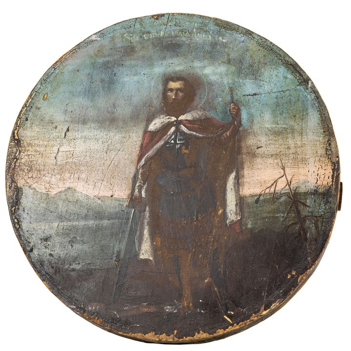 A Spanish Colonial retablo painting on board of a Saint with a book and a staff