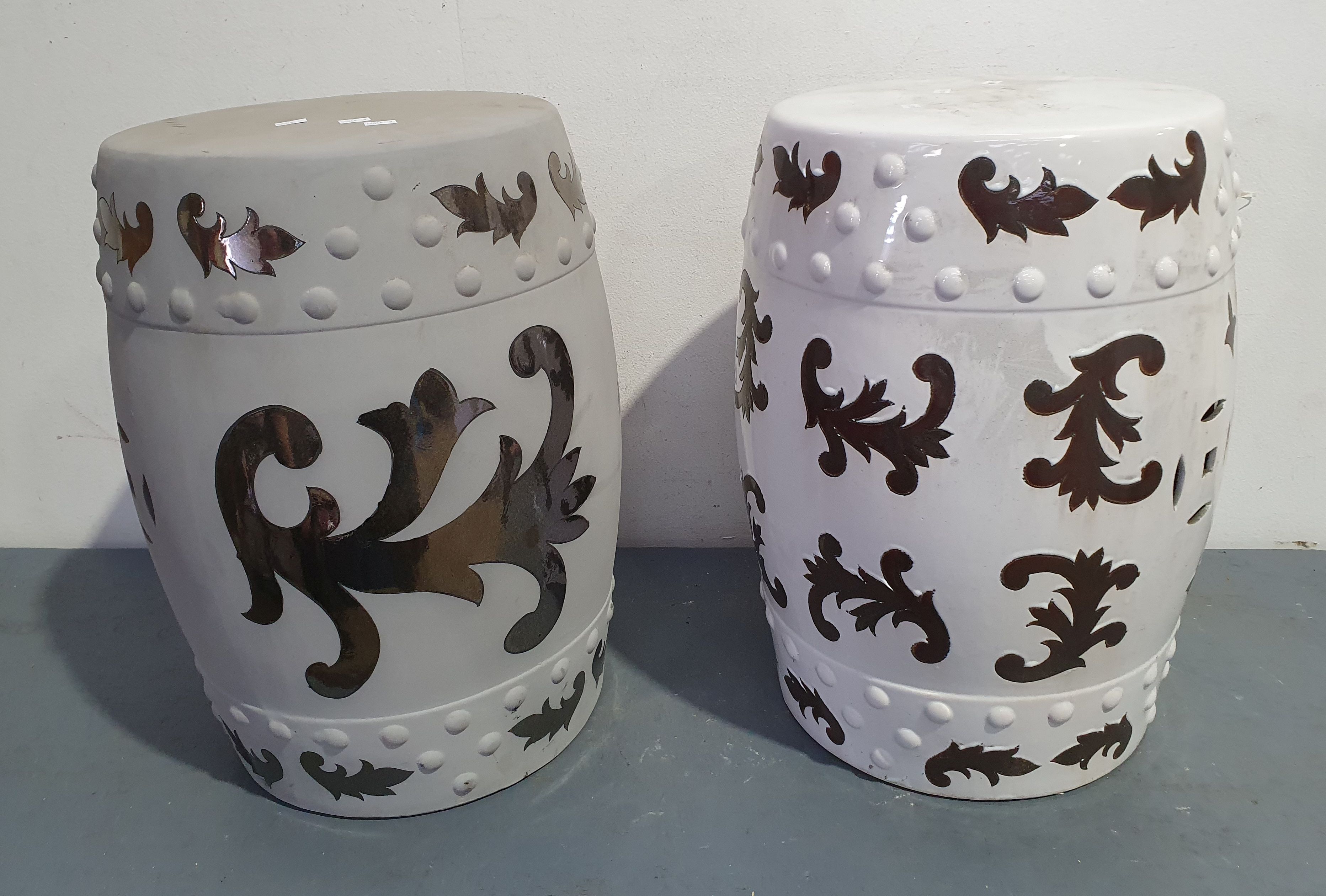 A Near Pair Of Ceramic Stools
