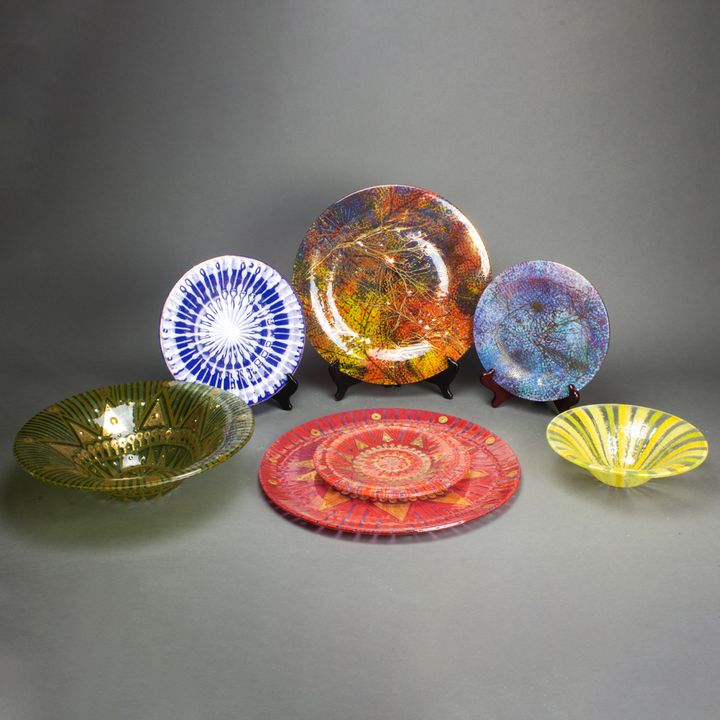 A group of seven Higgins gilt decorated fused glass plates