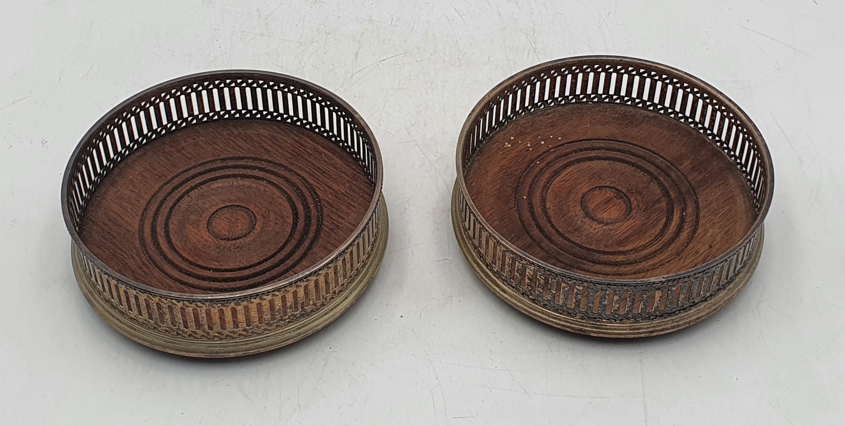 TWO LATE 19TH/ EARLY 20TH CENTURY SILVER PLATED BOTTLE COASTERS