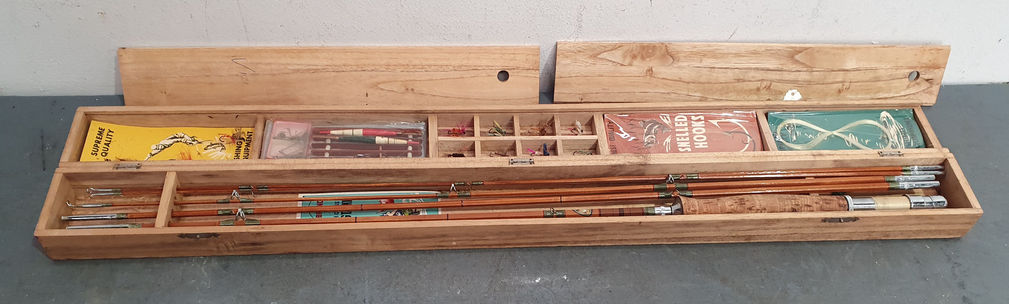 1311 · A CASED BAMBOO FLY FISHING ROD AND LURES