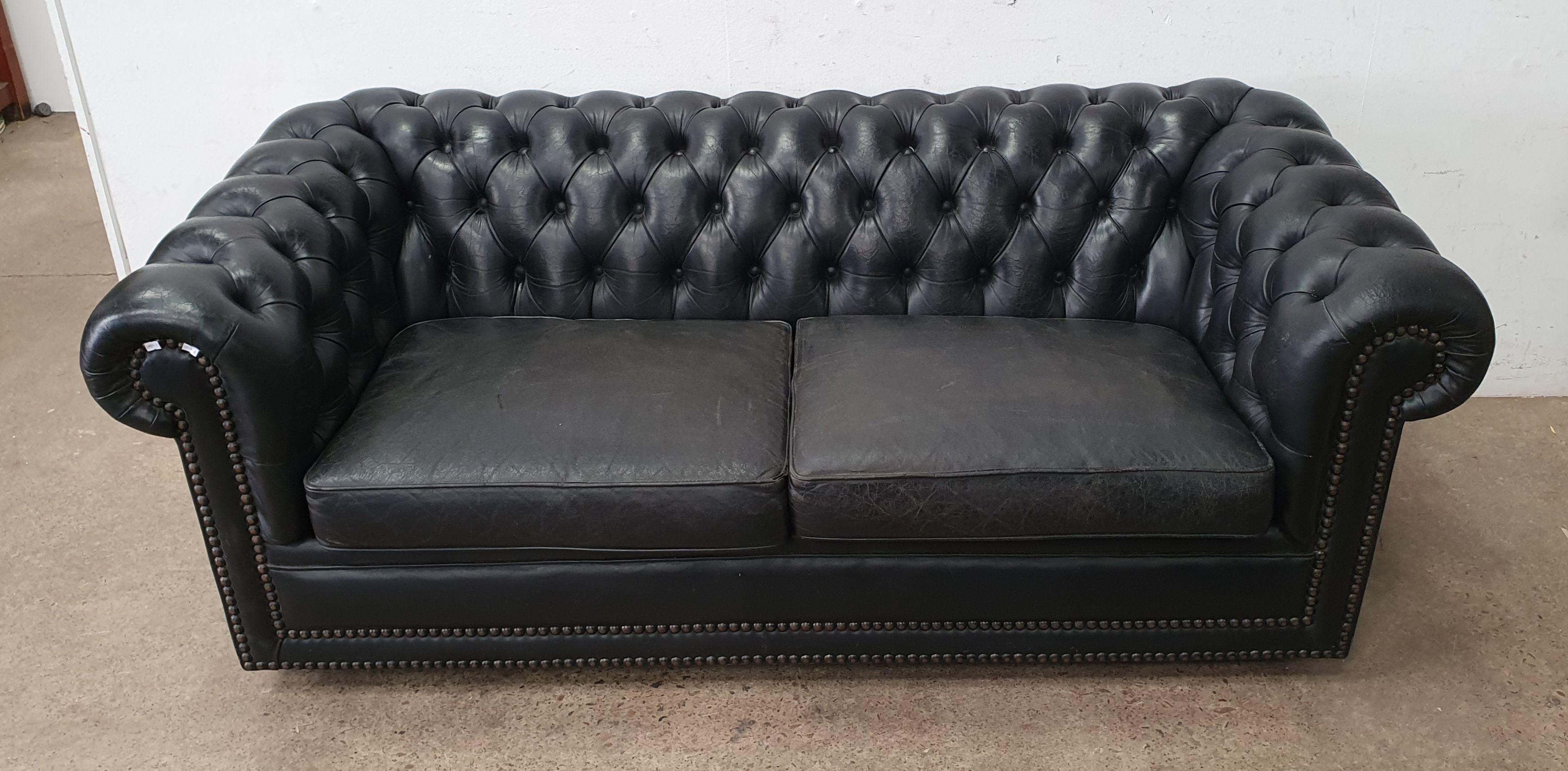 A Moran Leather Two Seater Button Back Chesterfield Sofa