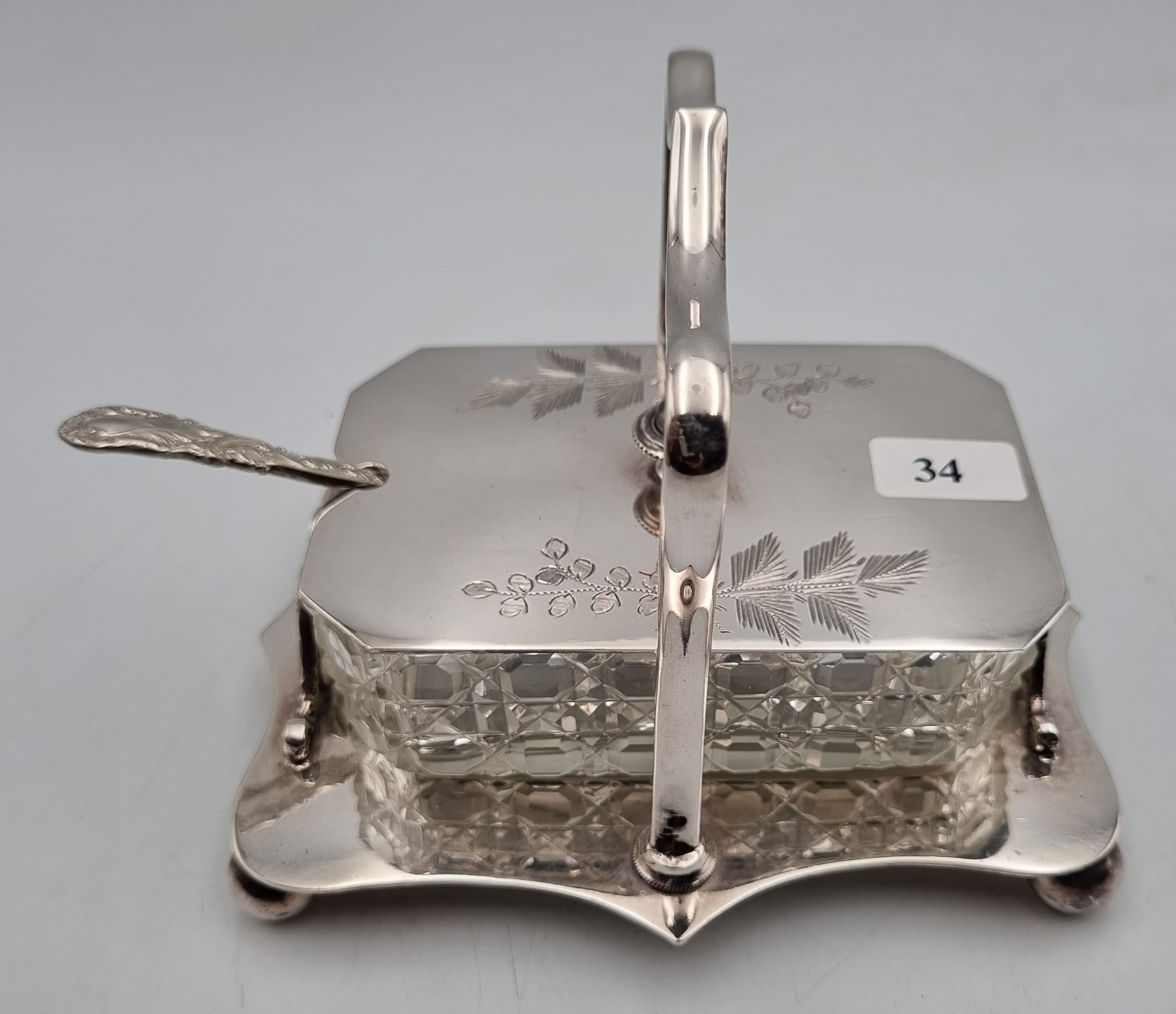 34 · AN EDWARDIAN SILVERPLATED BUTTER DISH WITH ORNATE BUTTER KNIFE