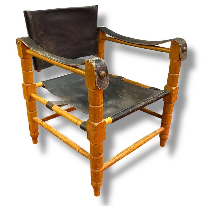 A Brutalist Mid Century Black Leather Safari Chair