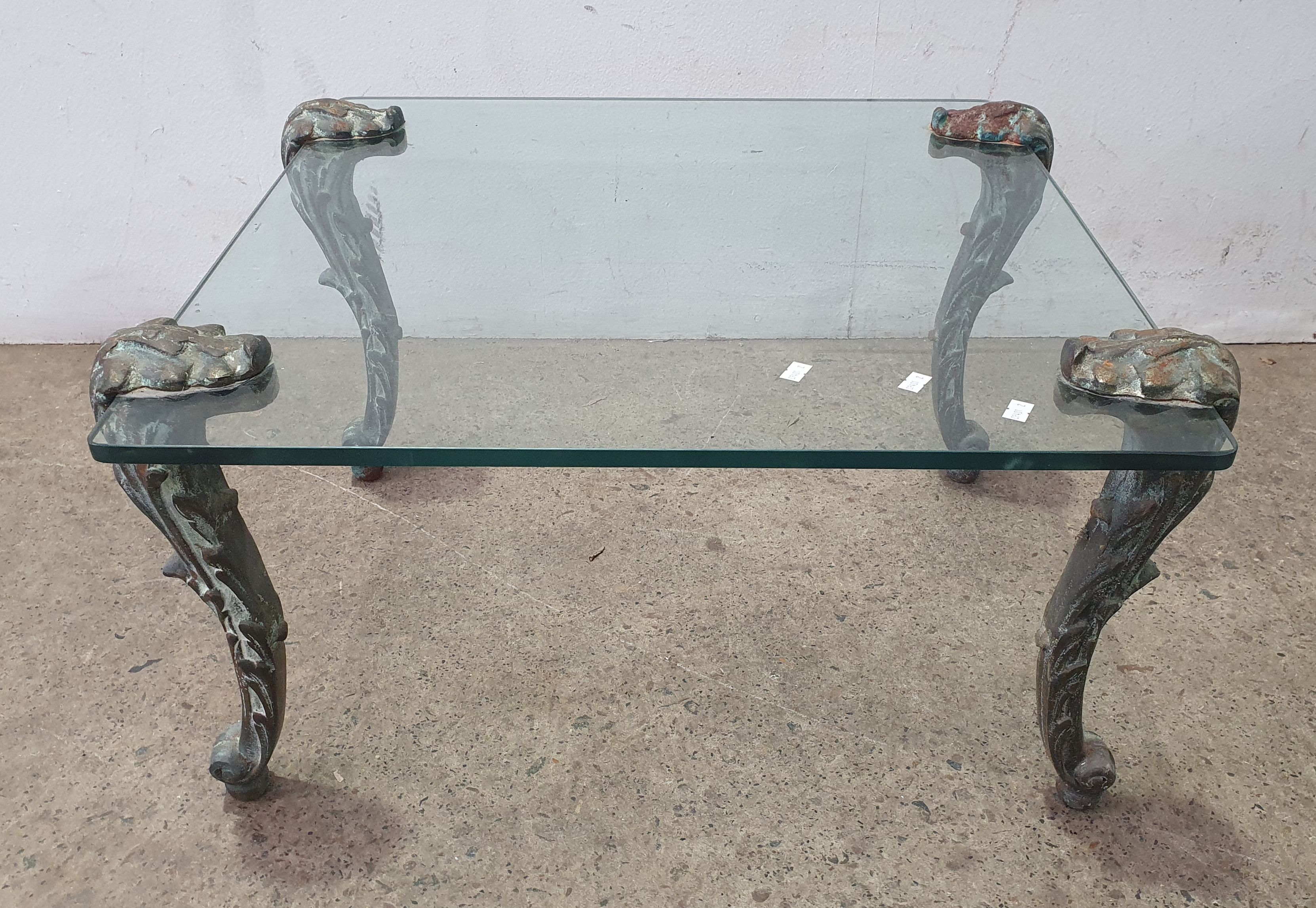 1033 · A METAL BASED GLASS TOP COFFEE TABLE