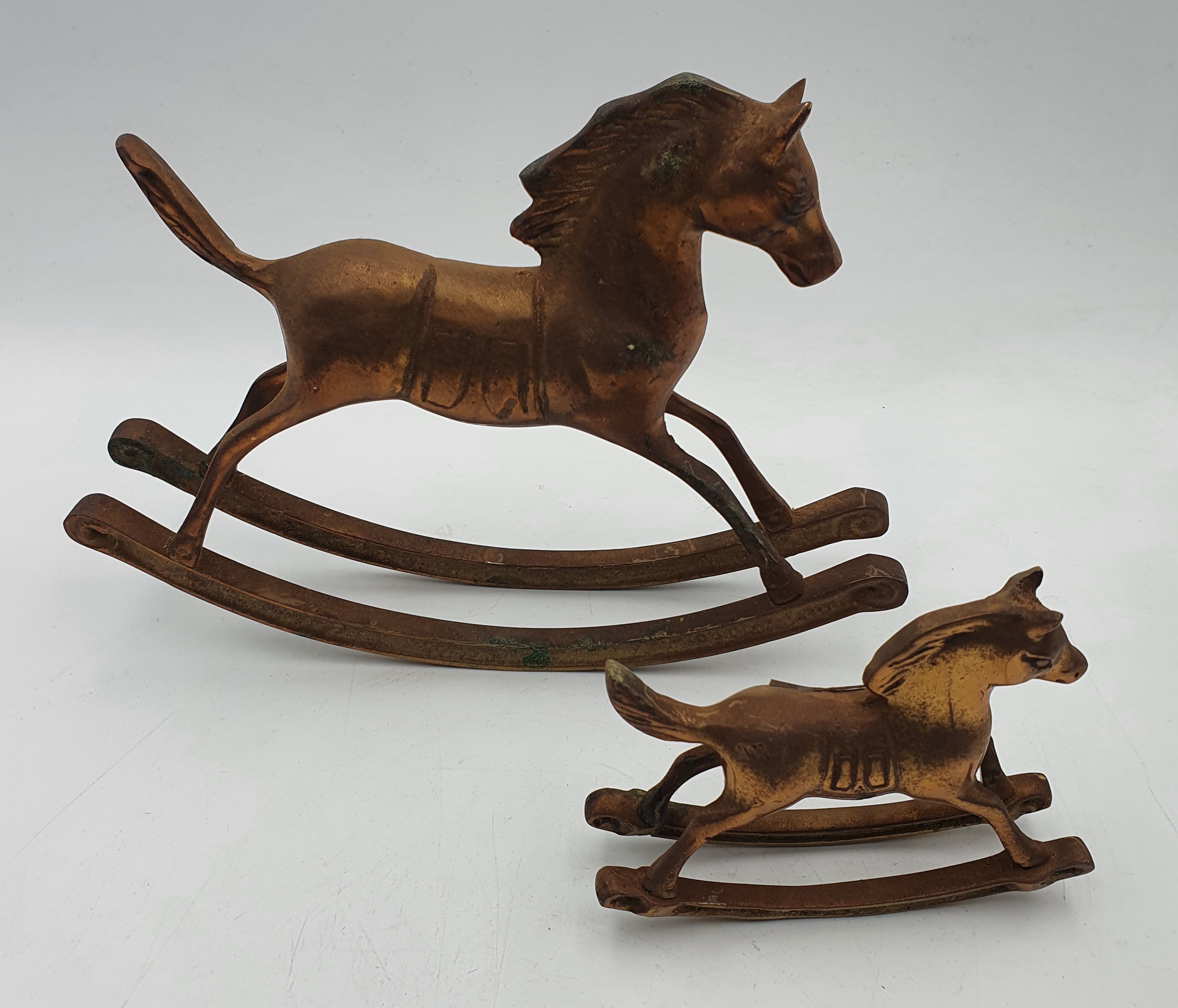 221 · TWO BRASS ROCKING HORSE FIGURES