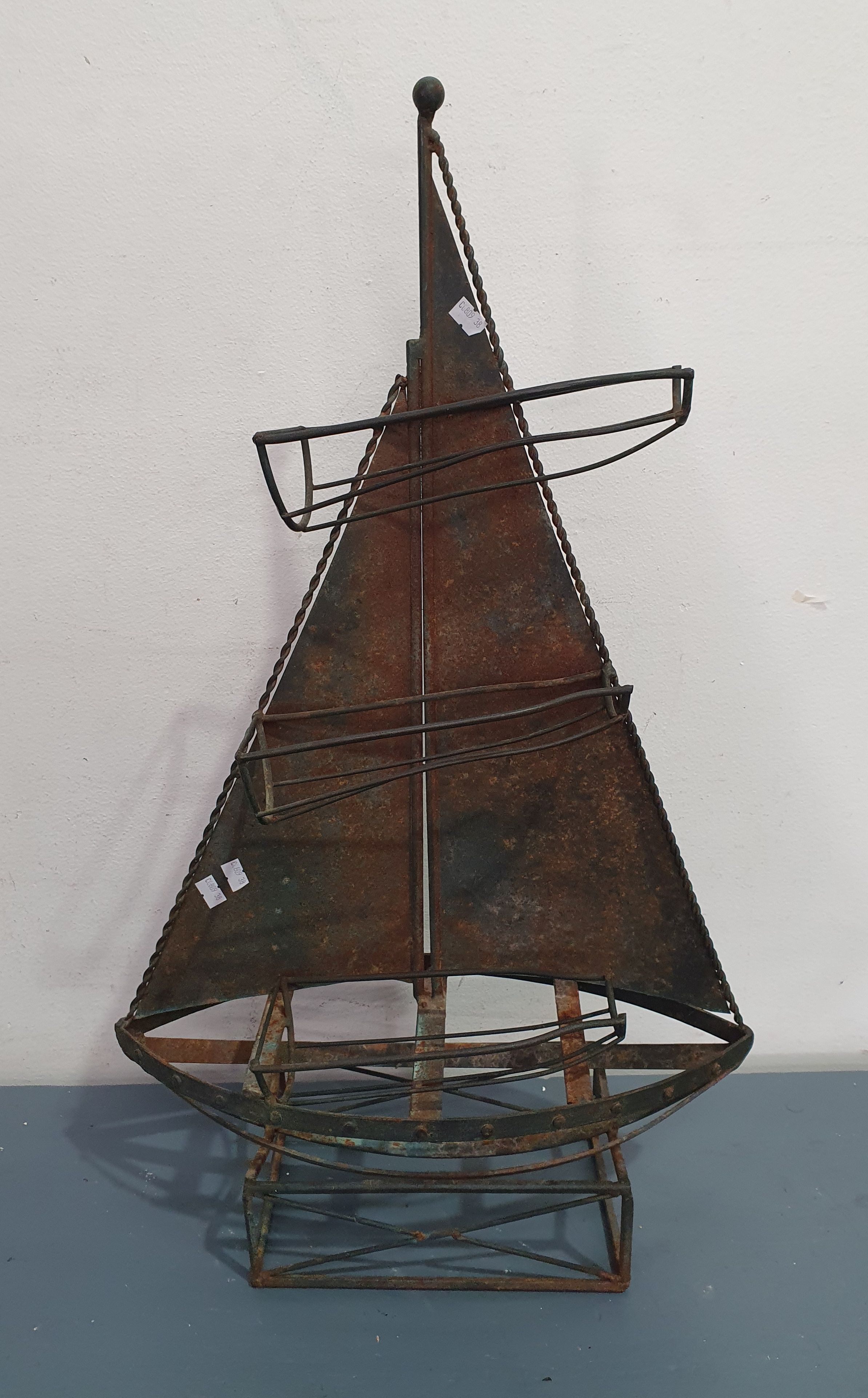 A Metal Yacht Form Wine Bottle Holder