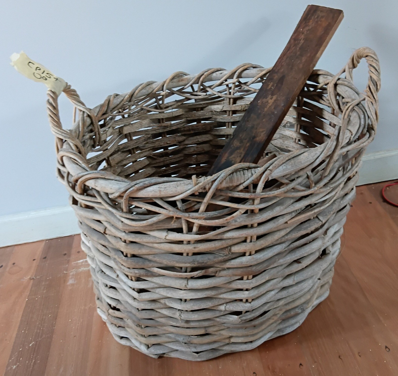 1045 · A CANE FIREWOOD BASKET
