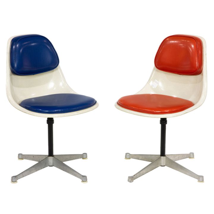 A pair of Eames style fiberglass shell swivel chairs