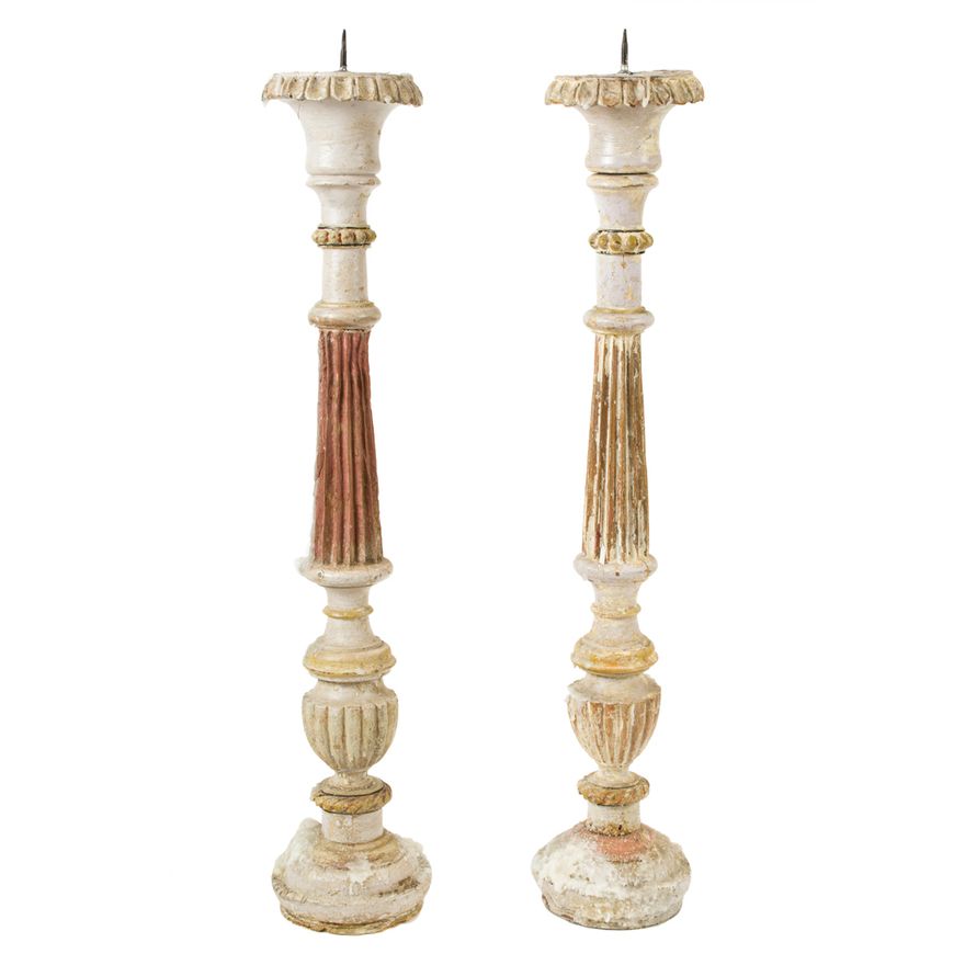 A pair of partial paint decorated columnar candle prickets in the Classical taste