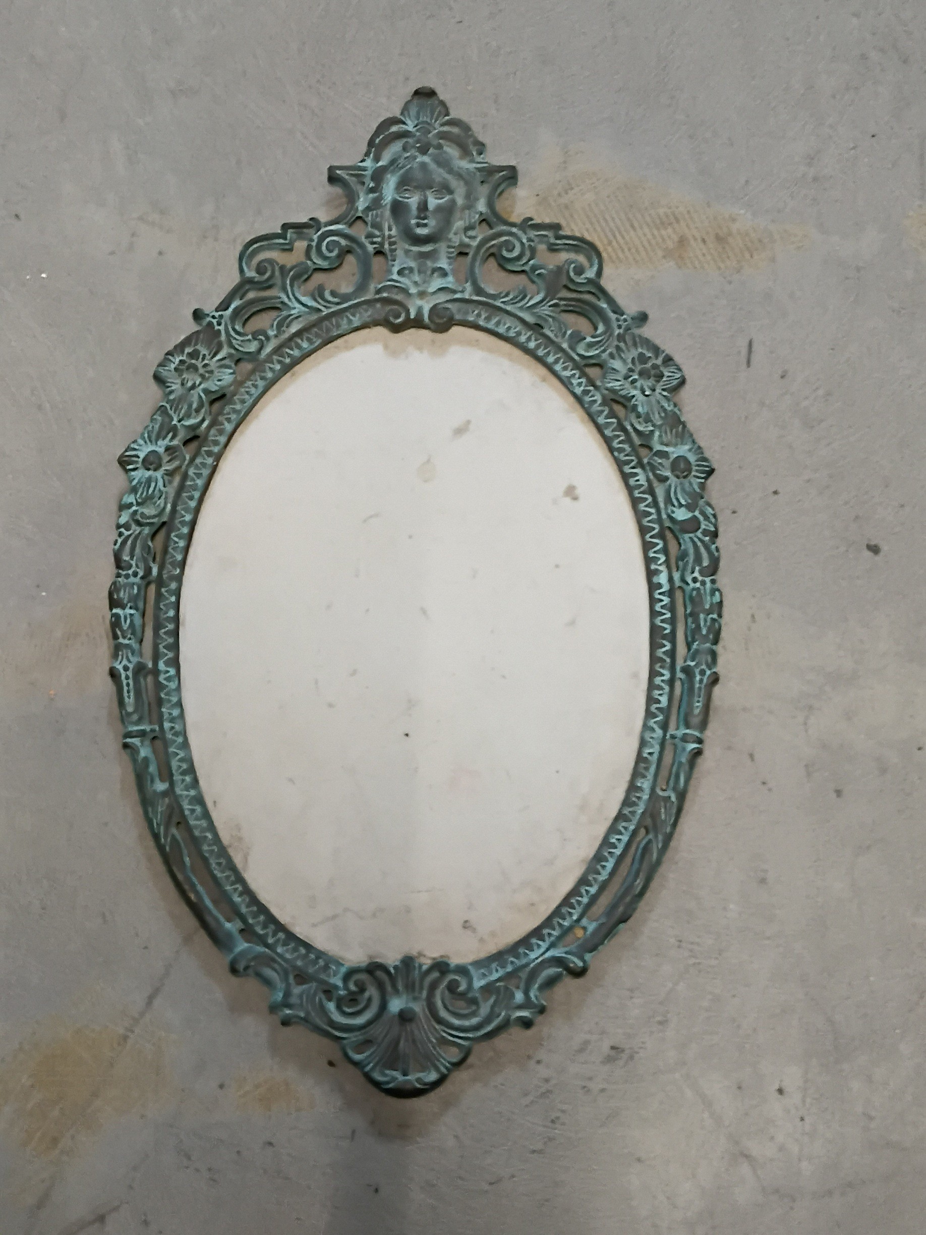 AN ORNATE CAST METAL FRAME