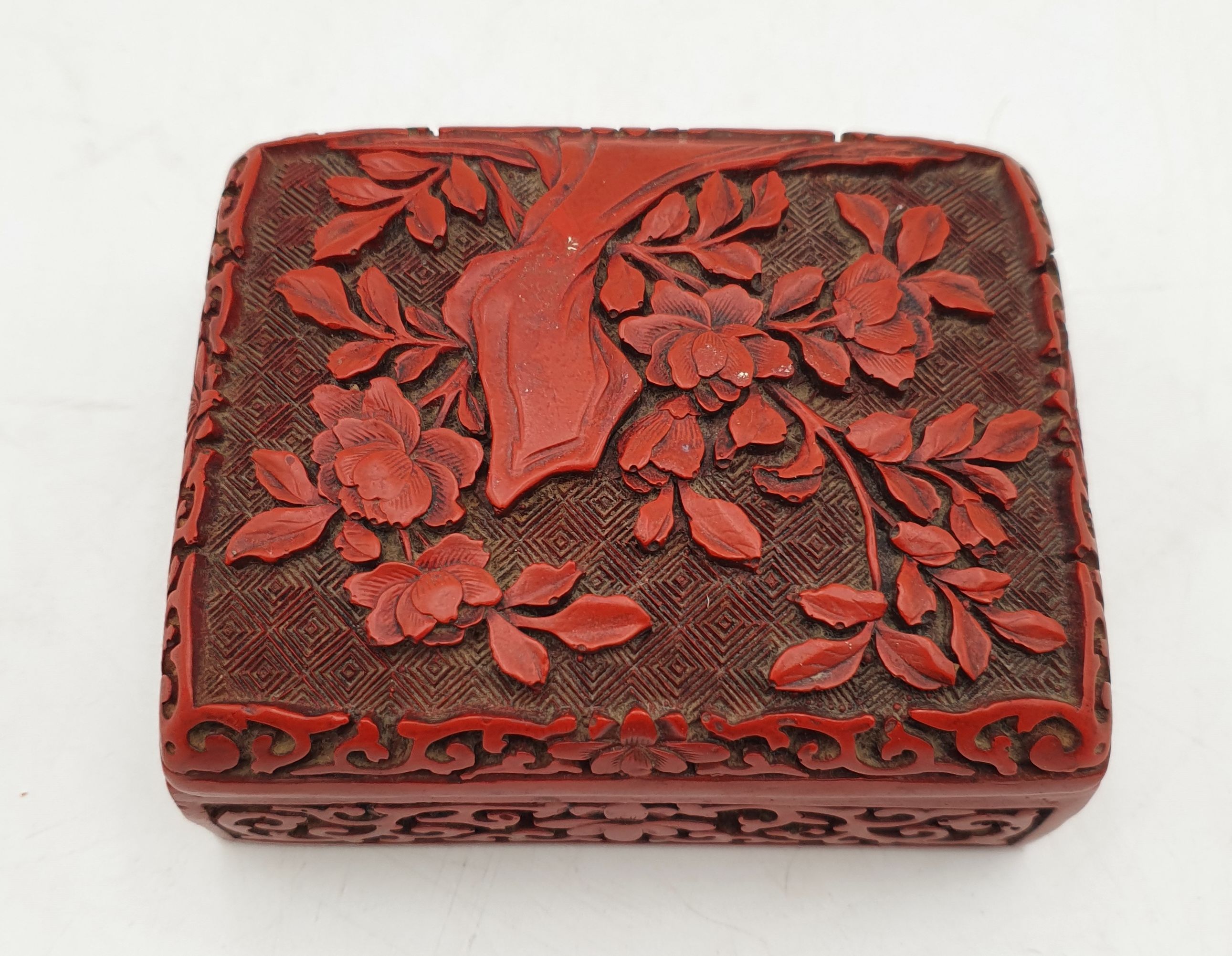 A CHINESE CARVED RED LACQUERED BOX