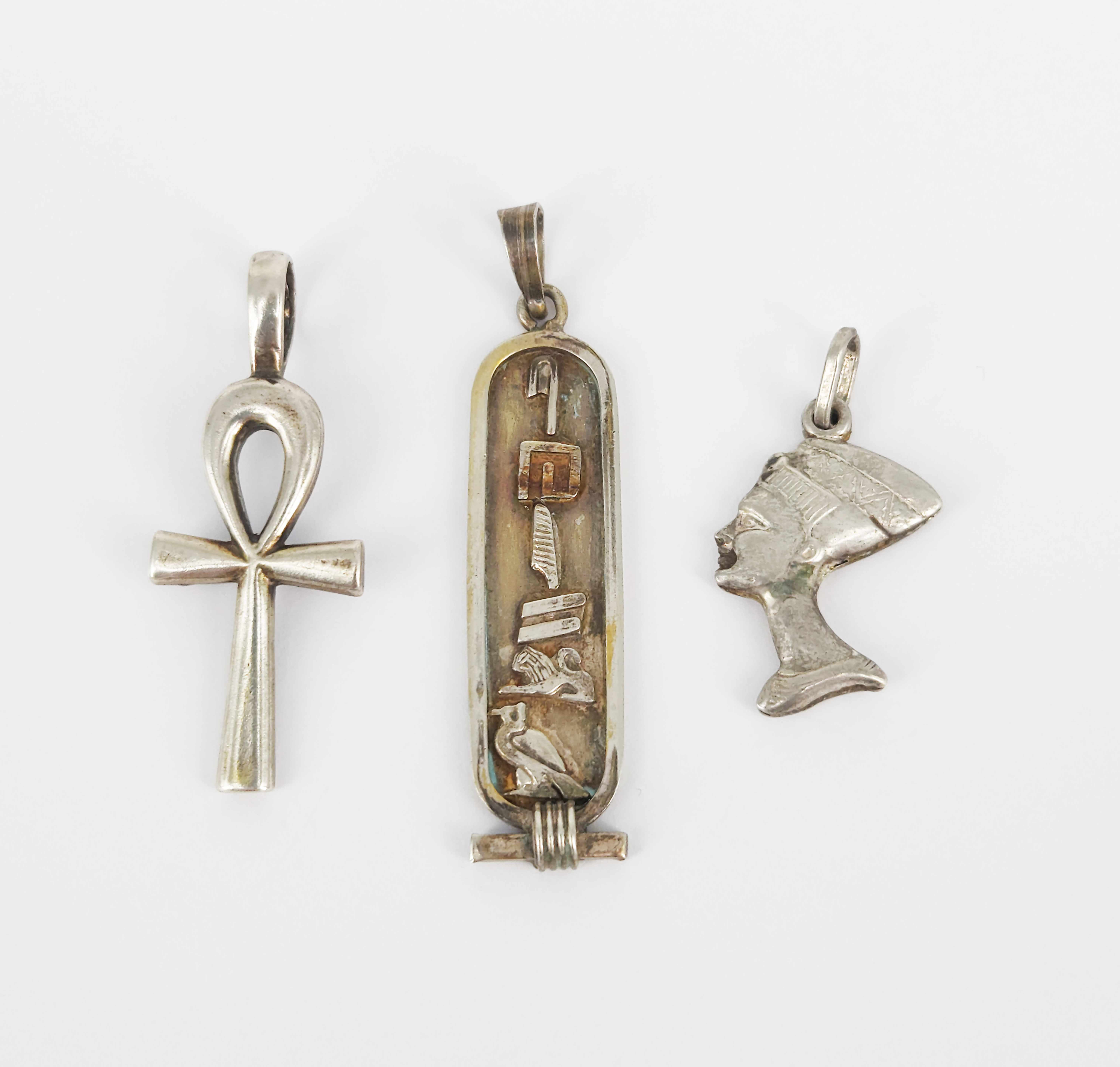 403 · THREE EGYPTIAN SILVER PENDANTS