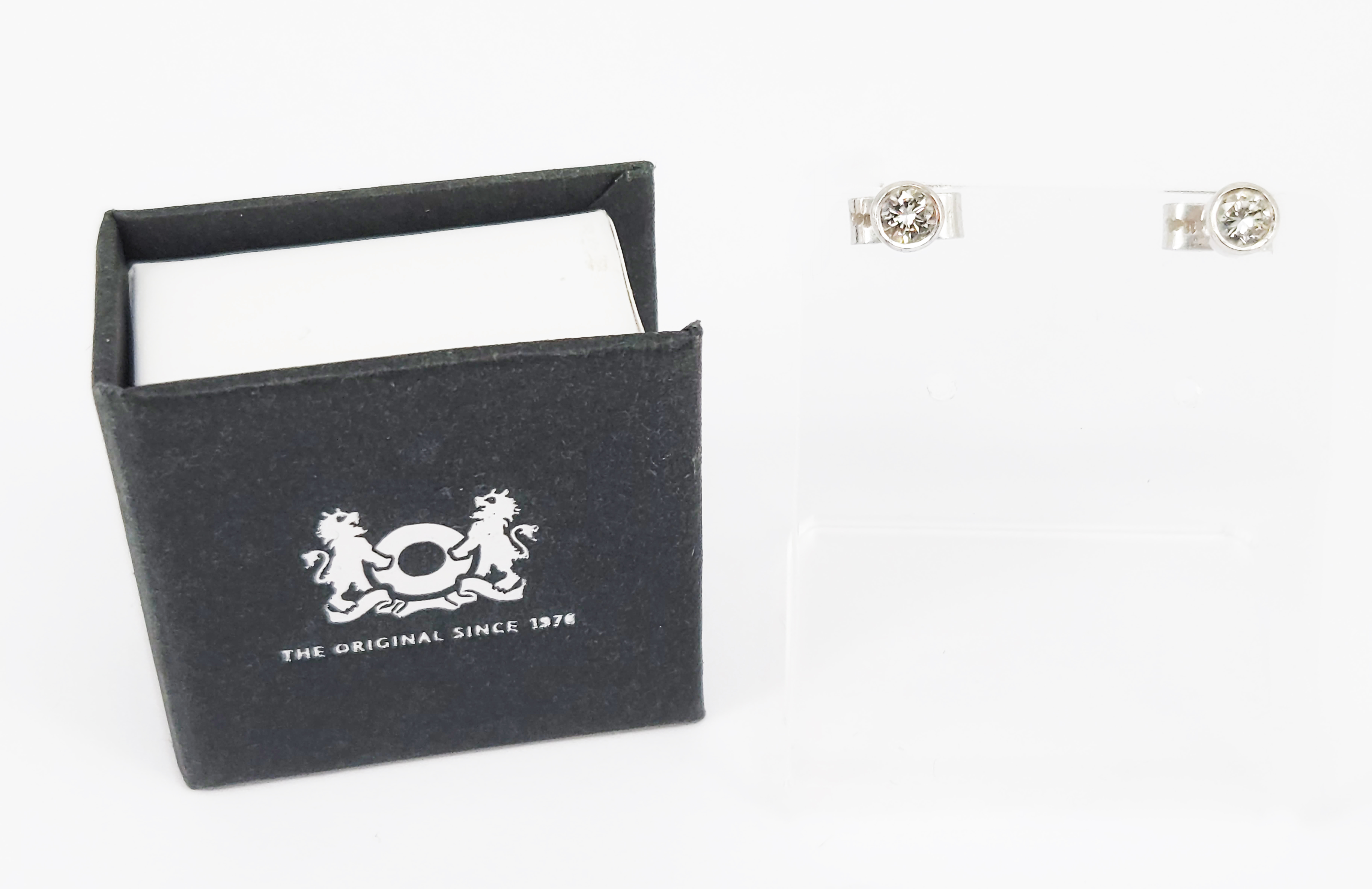 A Pair Of Designer 18k White Gold And Solitaire Diamond Earrings