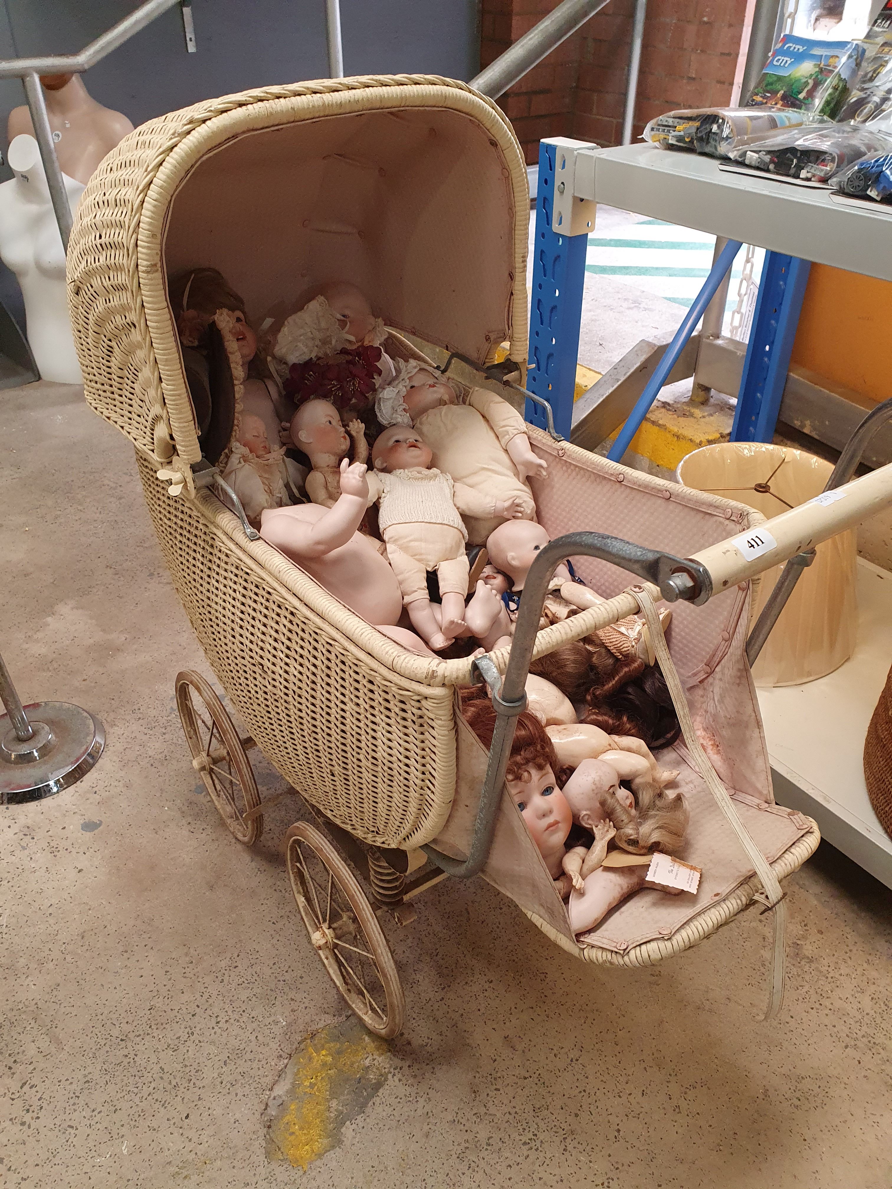 A VINTAGE WICKER PRAM AND MAINLY GERMAN DOLLS AND DOLL PARTS
