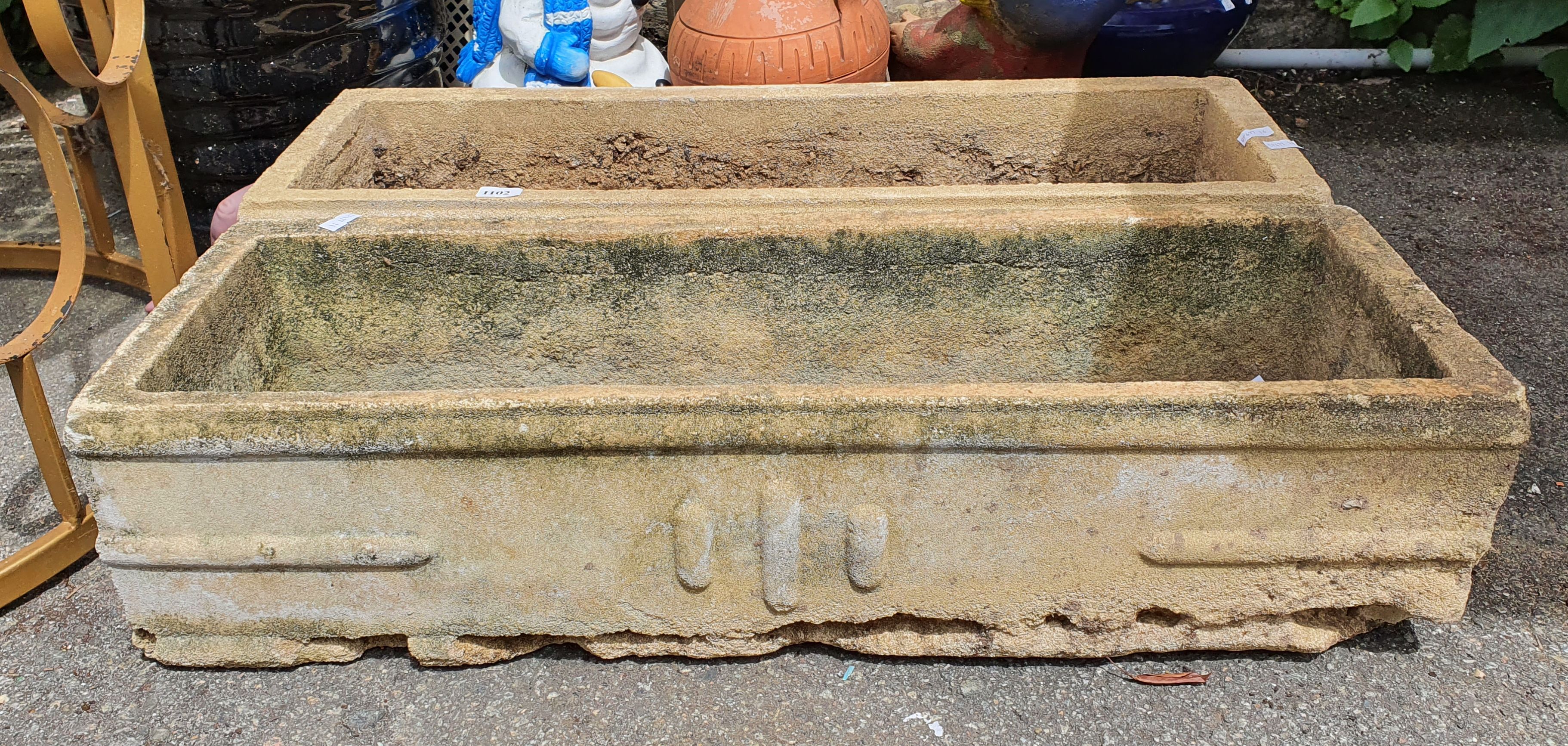 1102 · A PAIR OF CONCRETE POTS
