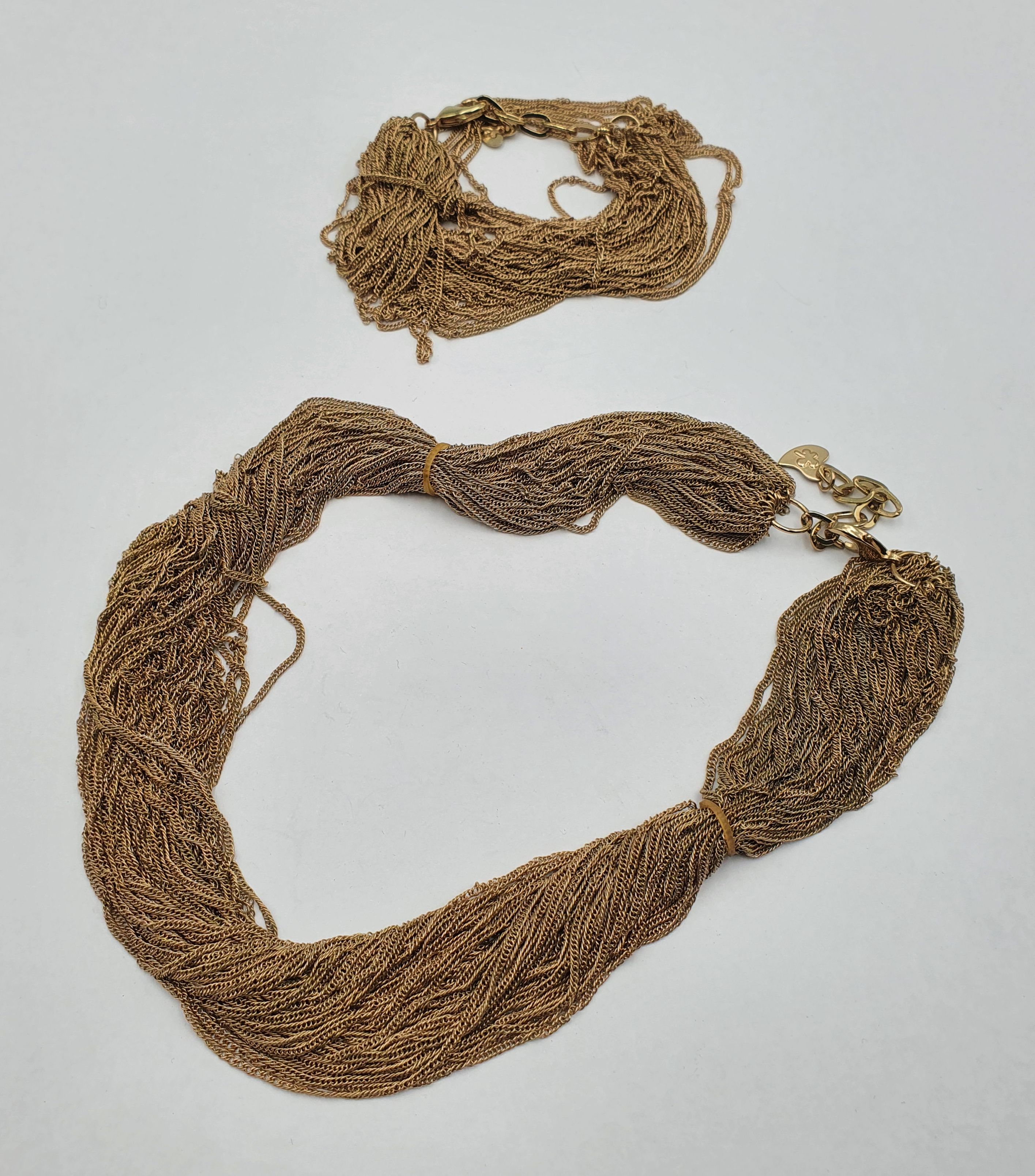 A HAUS OF DIETRICH MULTI CHAIN NECKLACE AND BRACELET SET