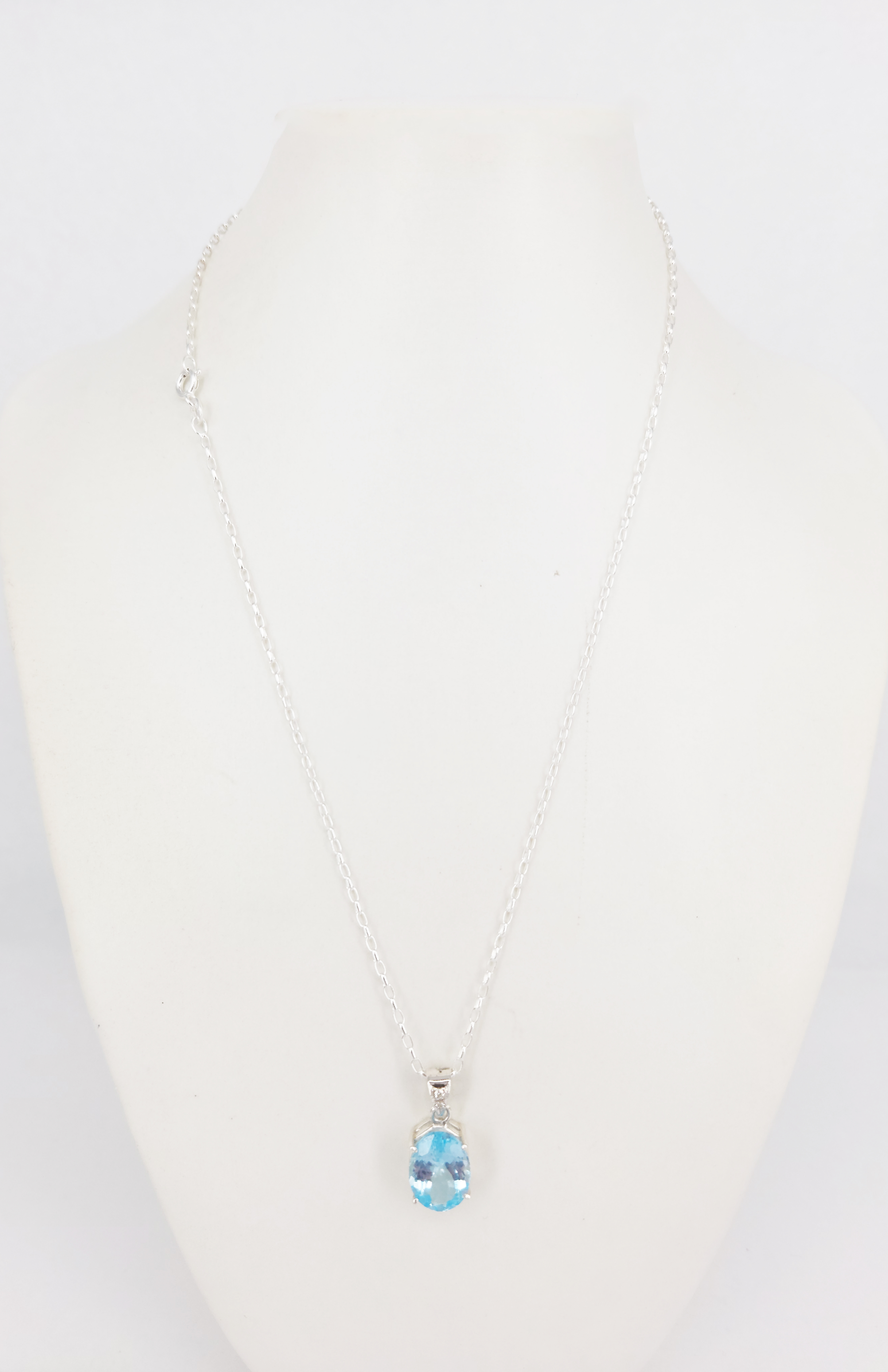 A Silver And Oval Blue Topaz Pendant Necklace