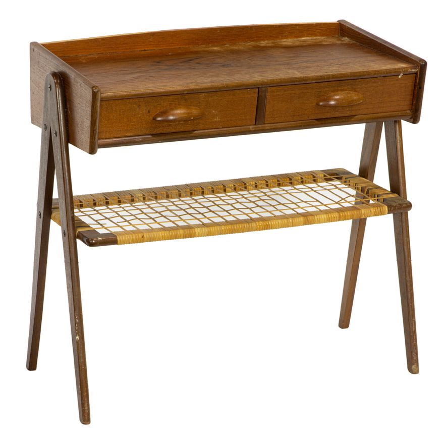 A Danish teak and rattan side table, the three quarter galleried top, over two side by side drawers, above a woven shelf, rising on ...