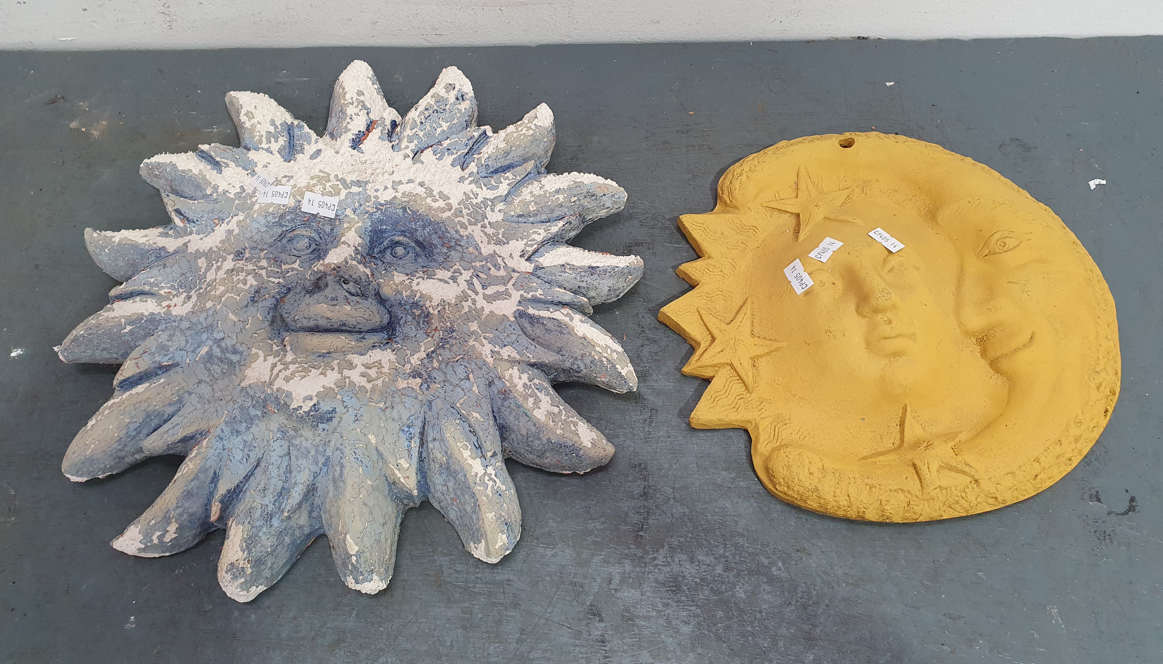 1091 · TWO TERRACOTTA SUN WALL PLAQUES