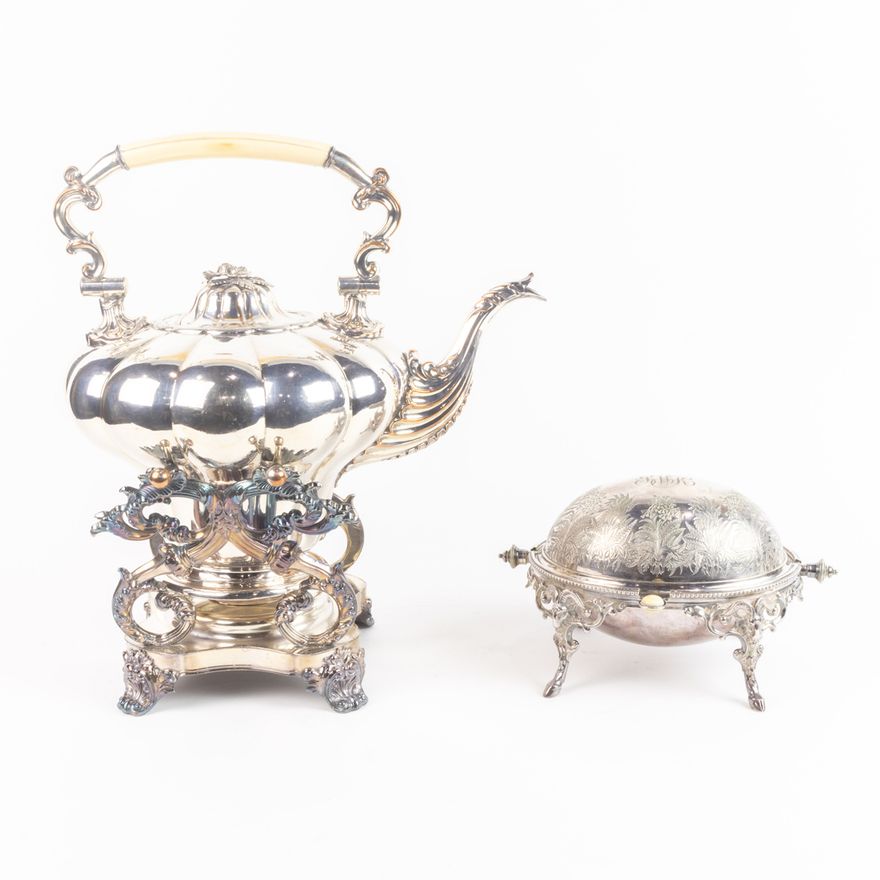 A Victorian Sheffield plate hot water urn on stand with a bone handle; en suite with an Aestethic Movement butter server with engrav...