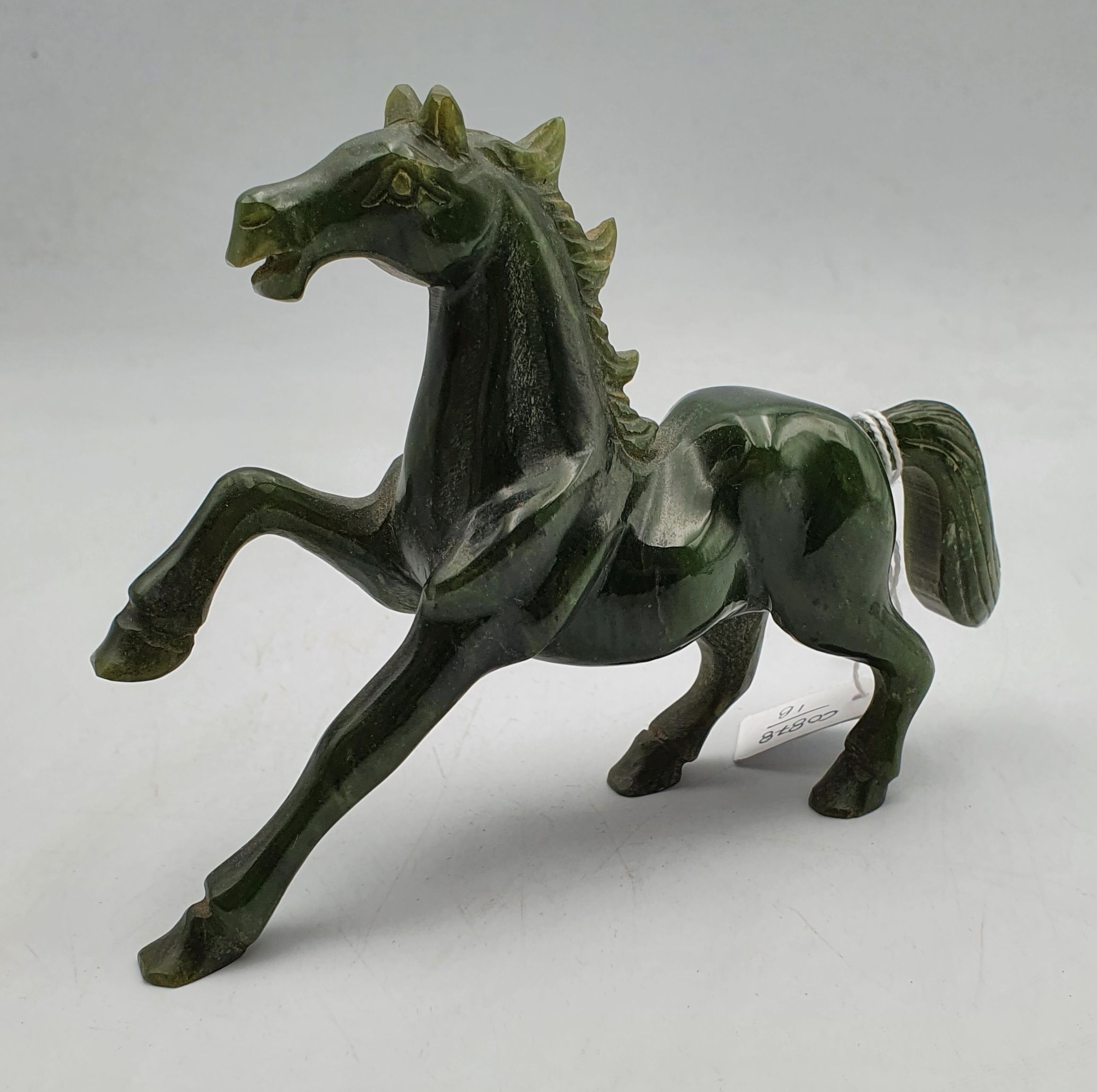 256 · A CARVED GREEN STONE HORSE
