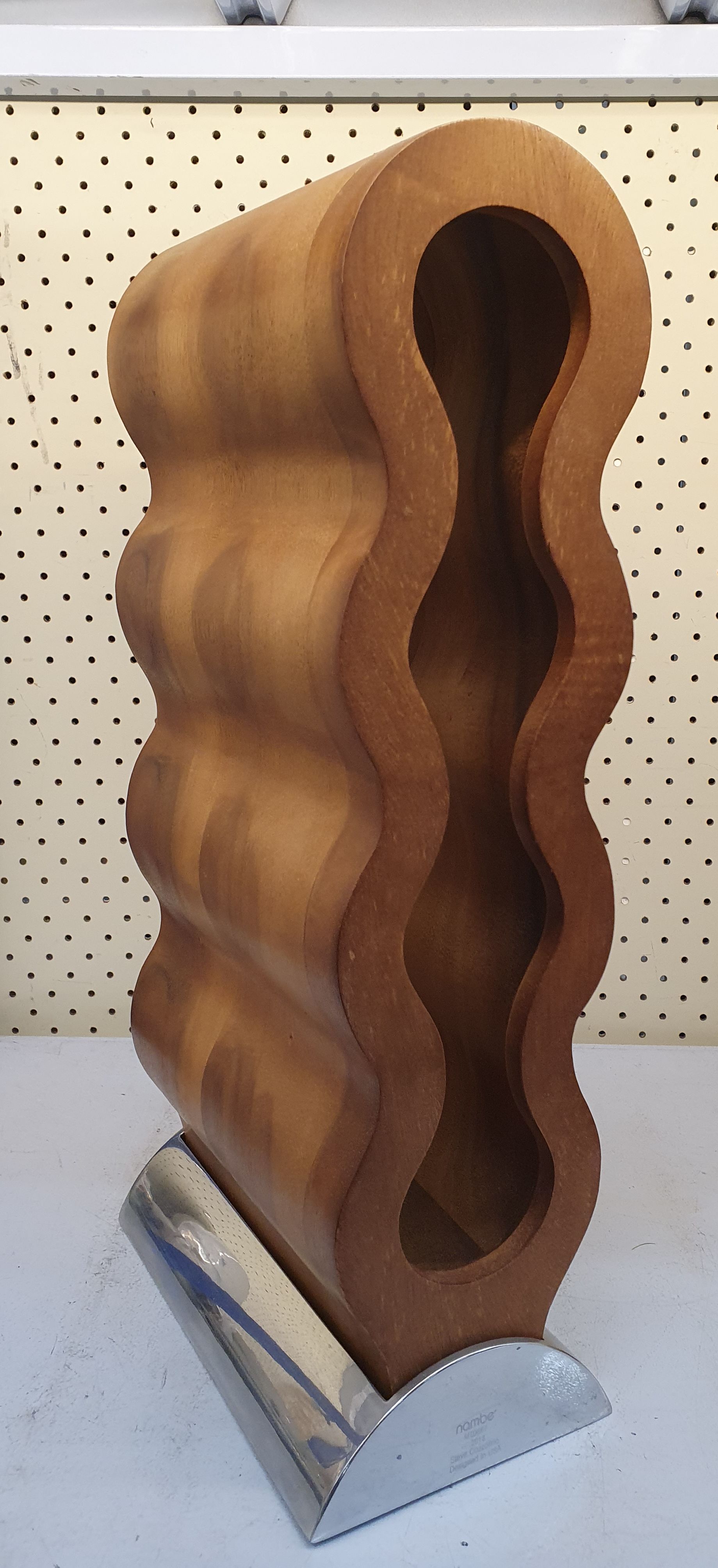 57 · A NAMBE CURVO WINE RACK DESIGNED BY STEVE COZZOLINO