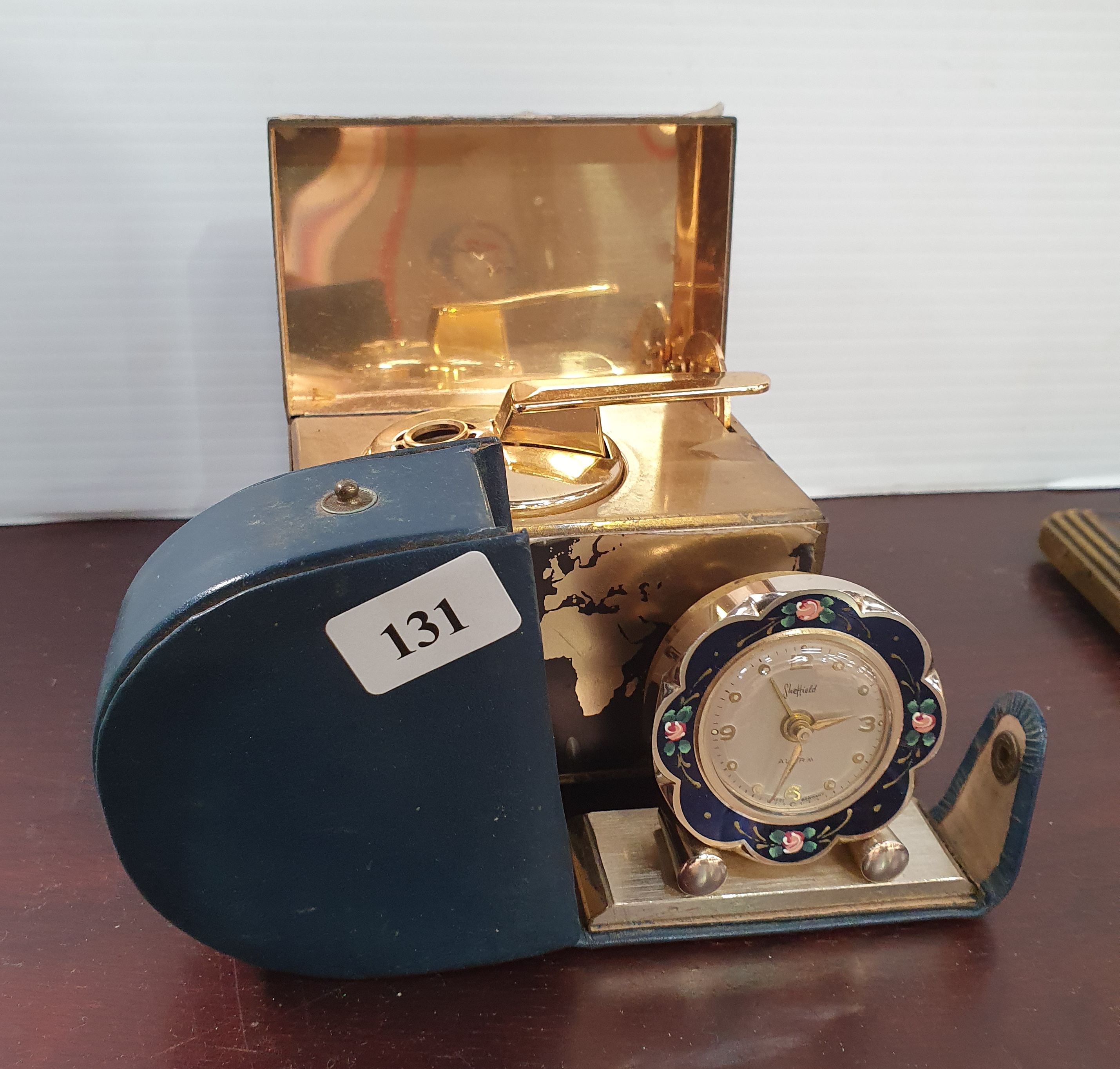 131 · A MUSICAL TABLE LIGHTER AND A SHEFFIELD TRAVEL CLOCK
