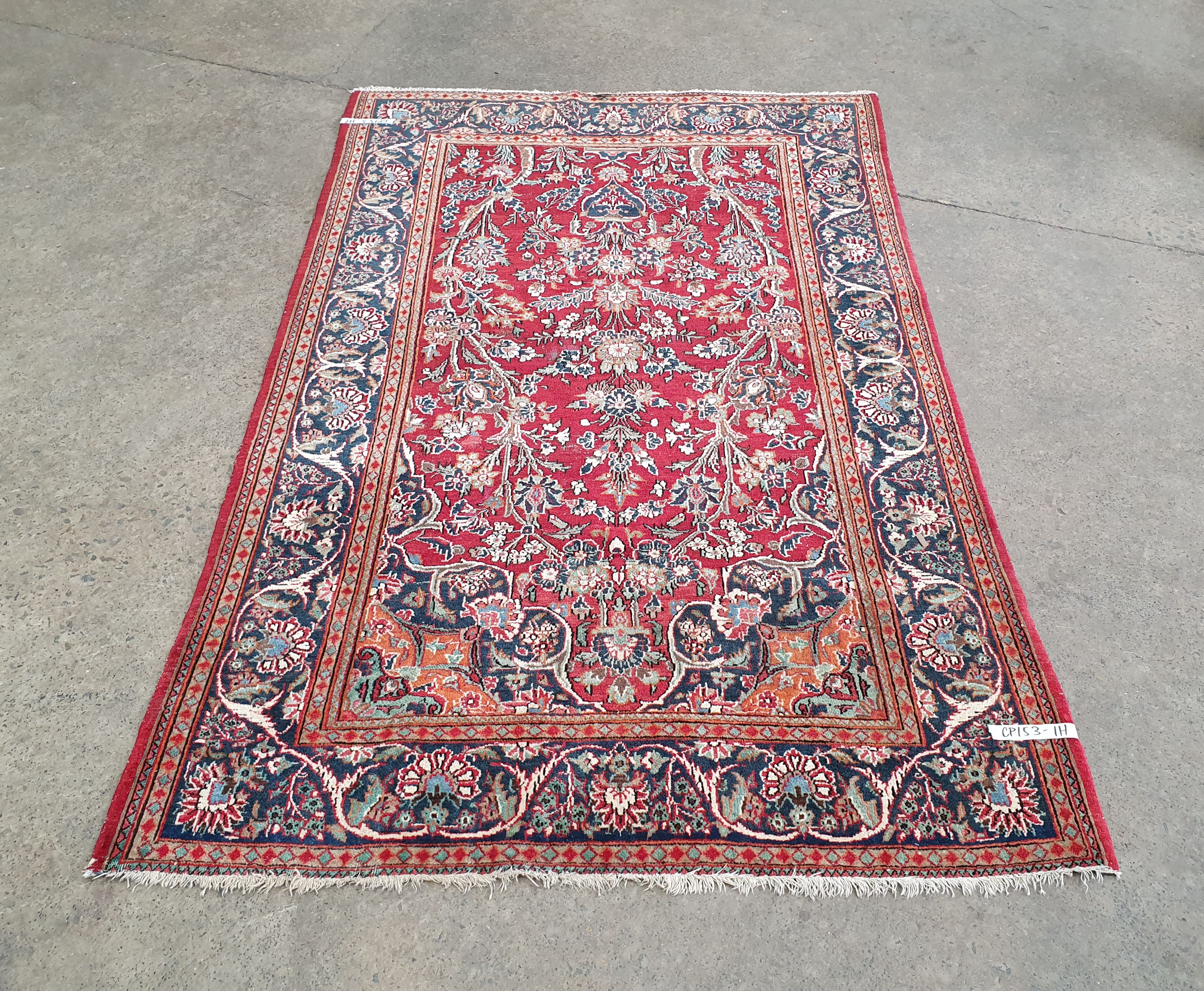 A Hand Knotted Wool Rug On Blue Field