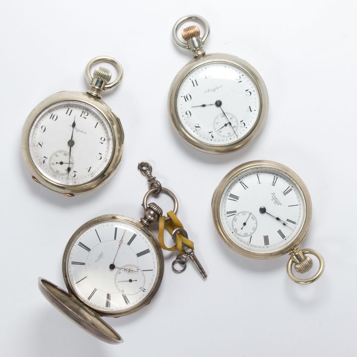 A group of silver pocket watches