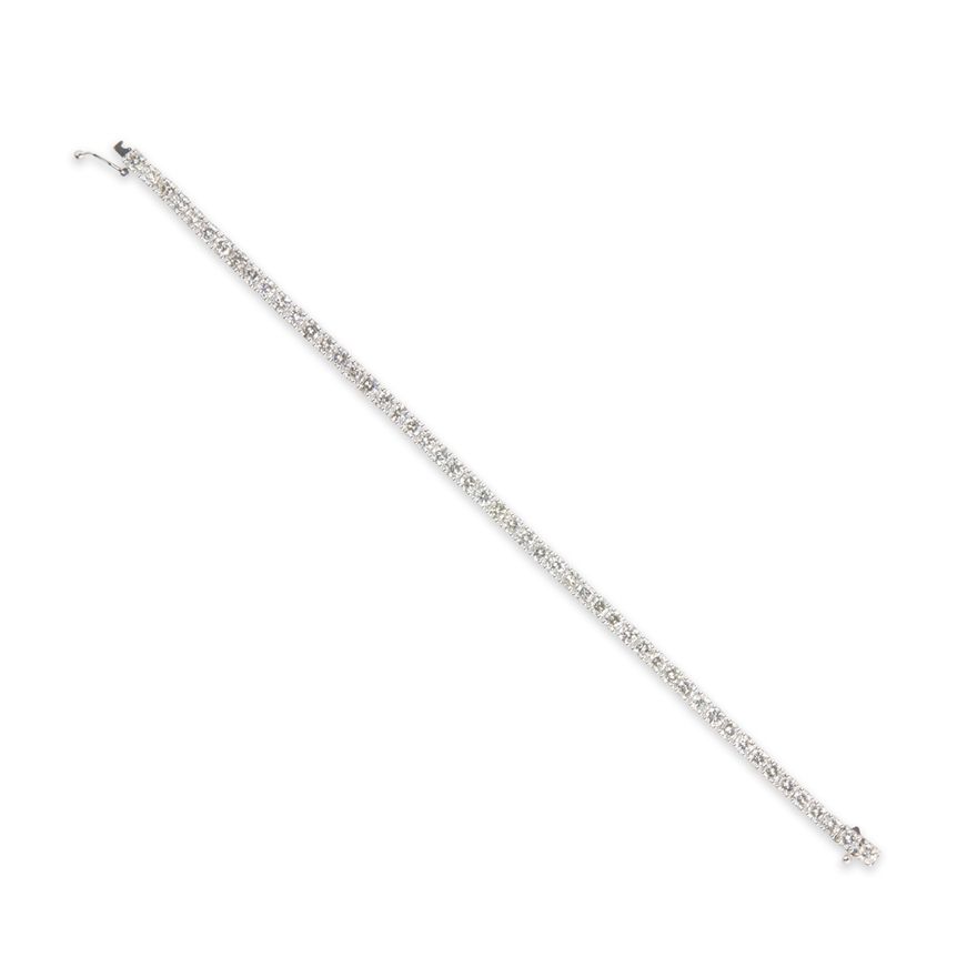 A diamond and fourteen karat white gold bracelet
