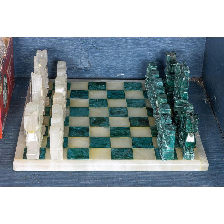 An onyx and agate chess set with large green and white chessboard