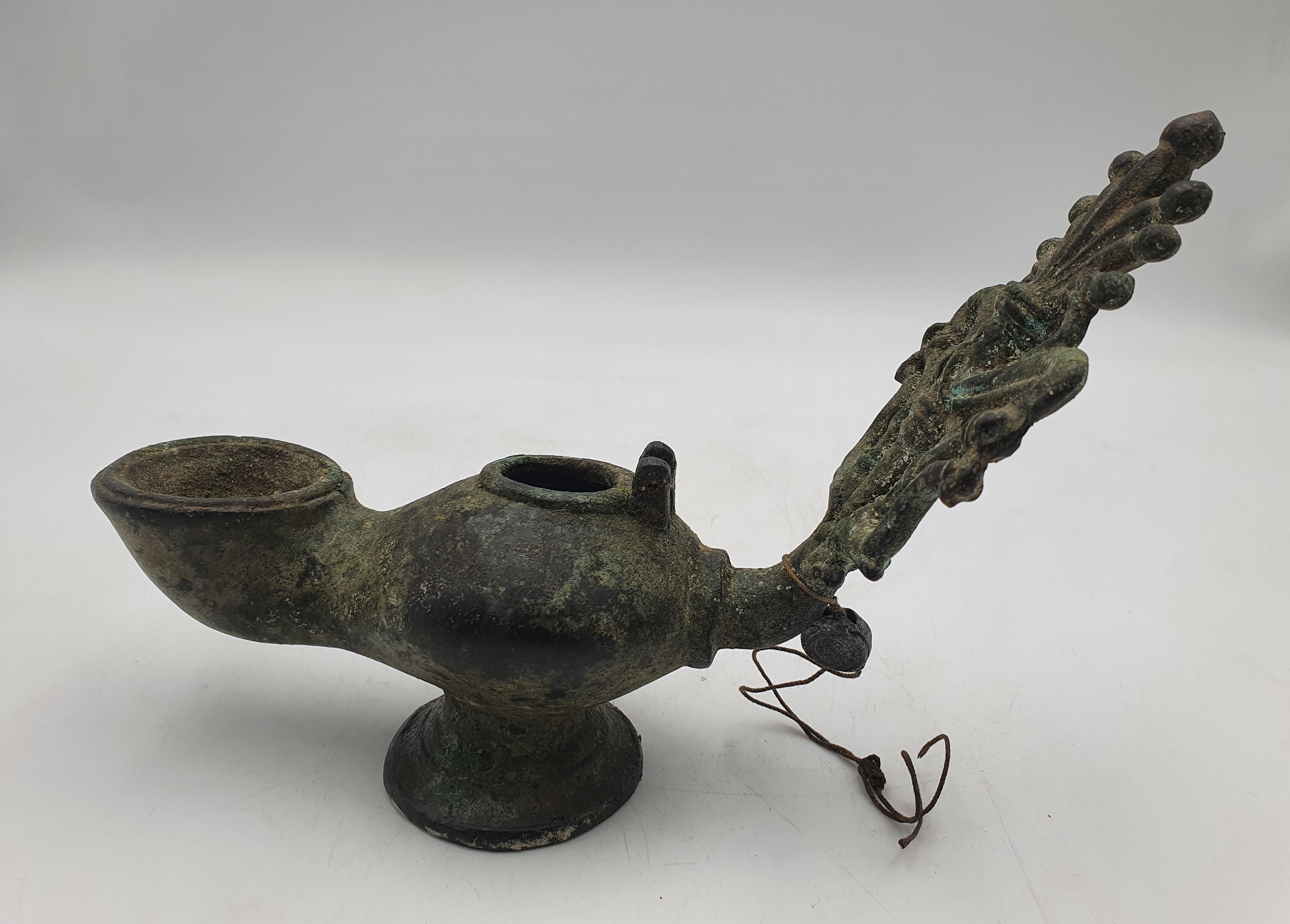 328 · A BYZANTINE BRONZE OIL LAMP