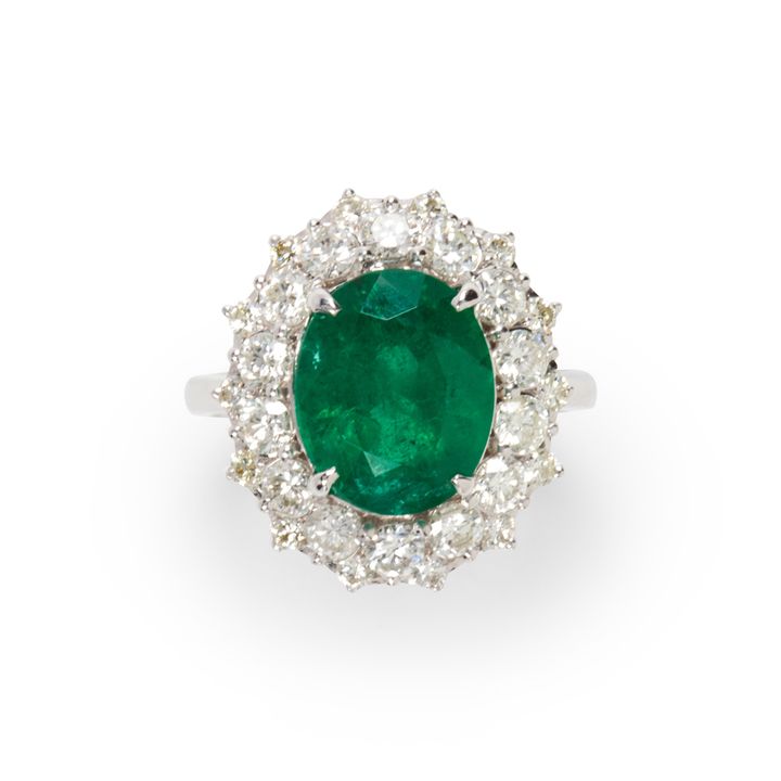 An emerald, diamond and eighteen karat white gold ring