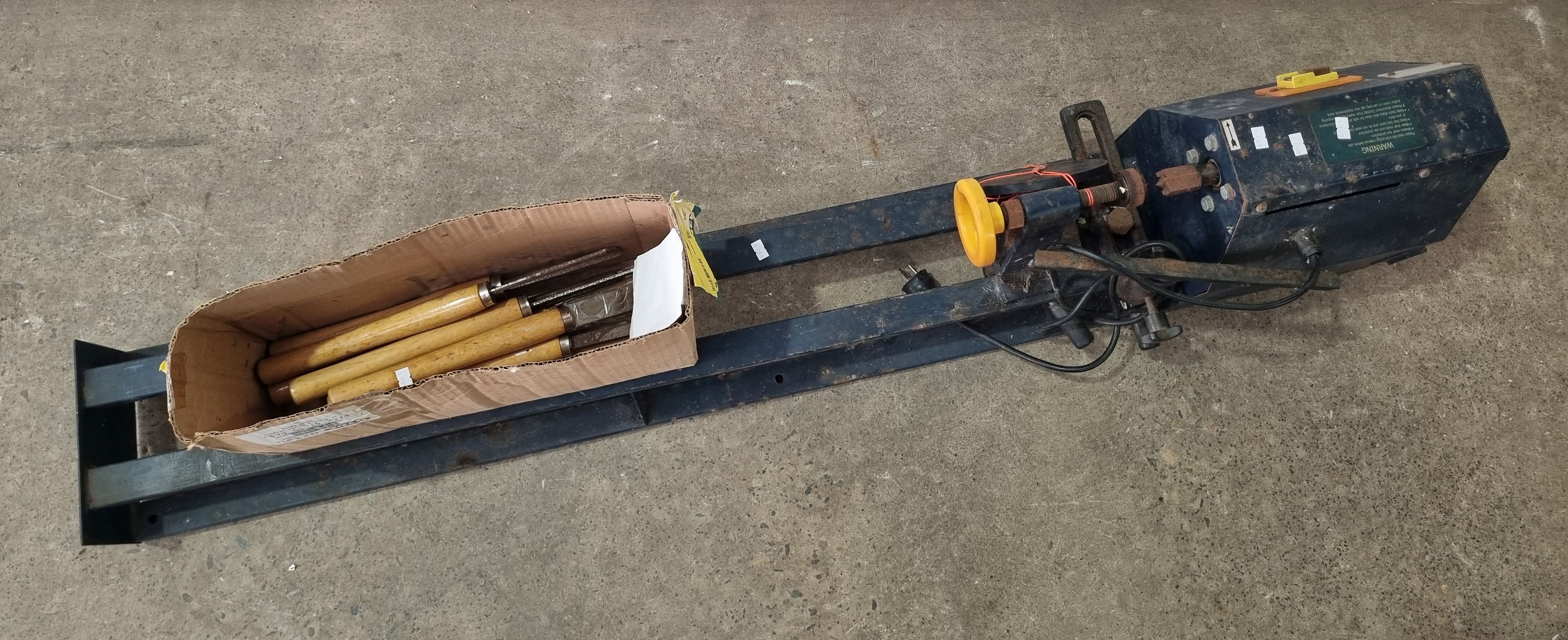 A GMC LATHE WITH A GROUP OF CHISELS
