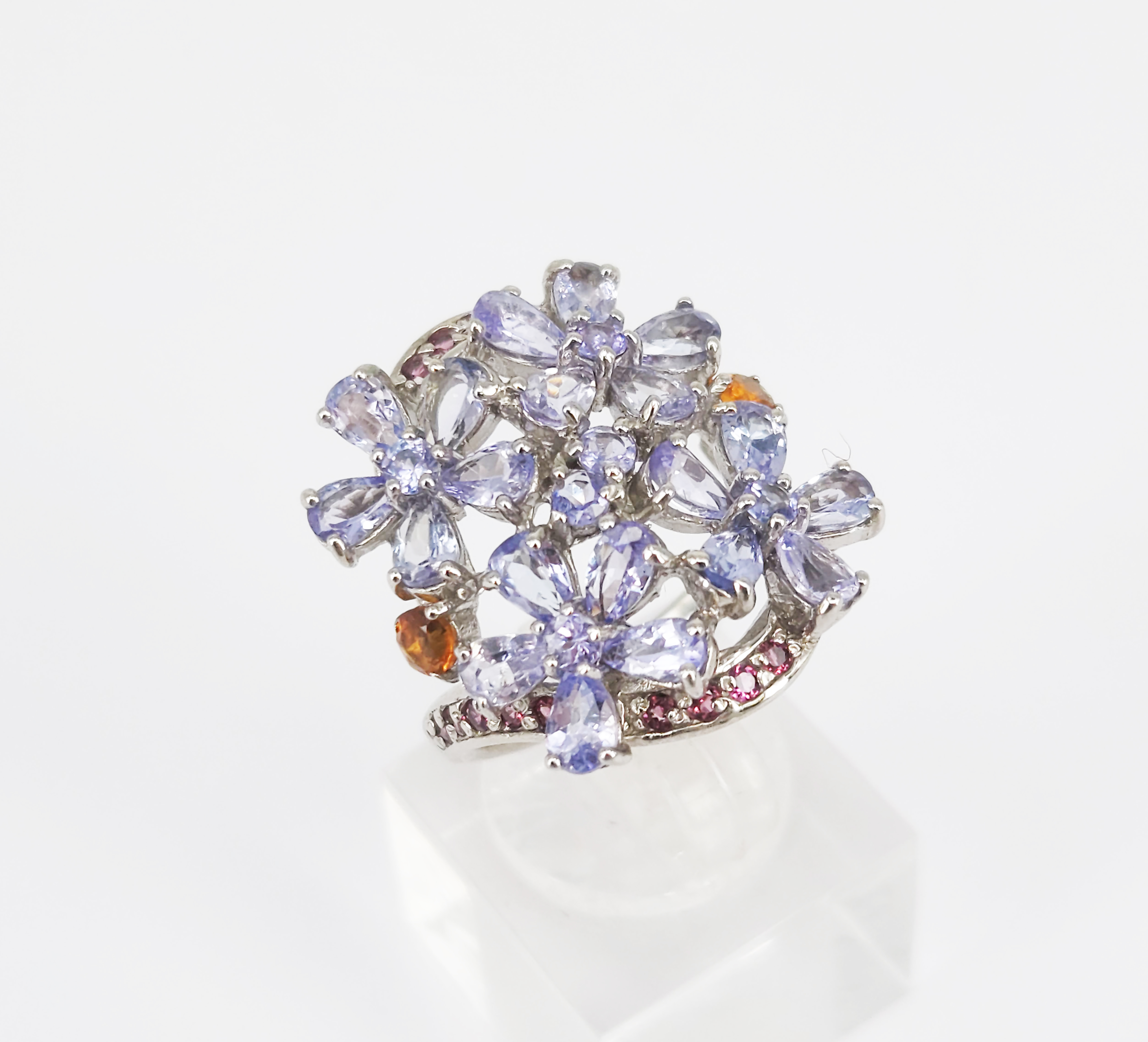 A Tazanite And Garnet Floral Cluster Silver Ring