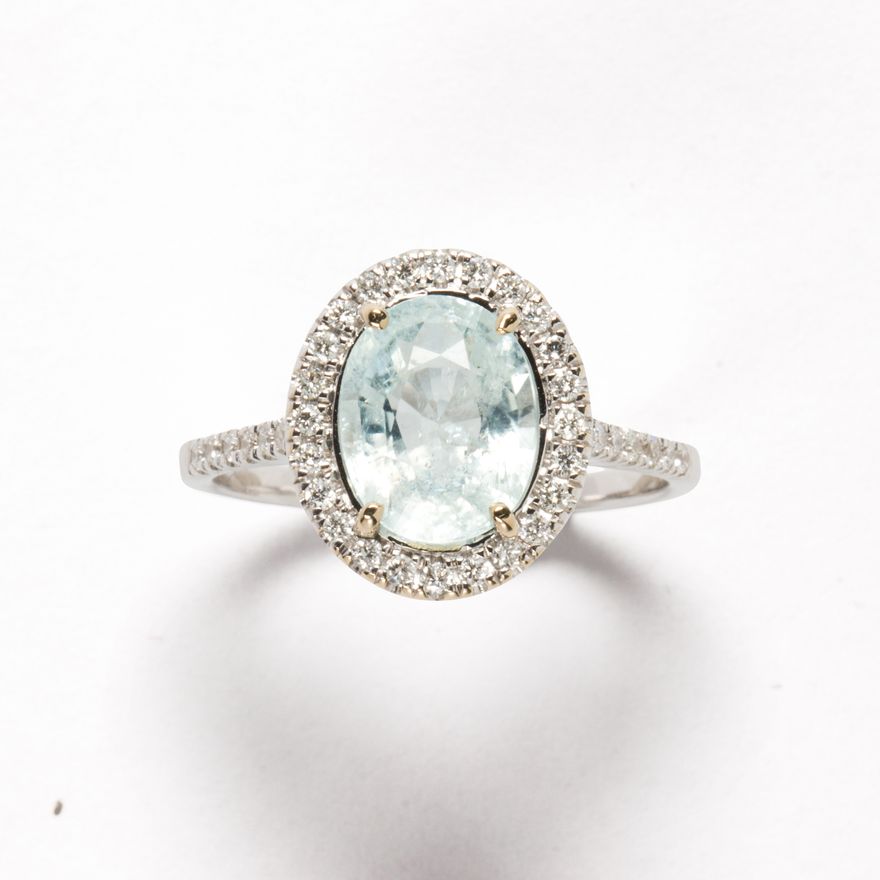 A very light blue tourmaline, diamond and eighteen karat white gold ring