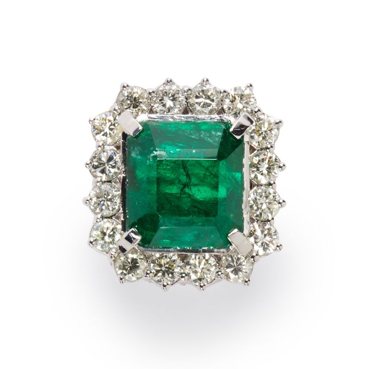 An emerald, diamond and eighteen karat white gold ring.