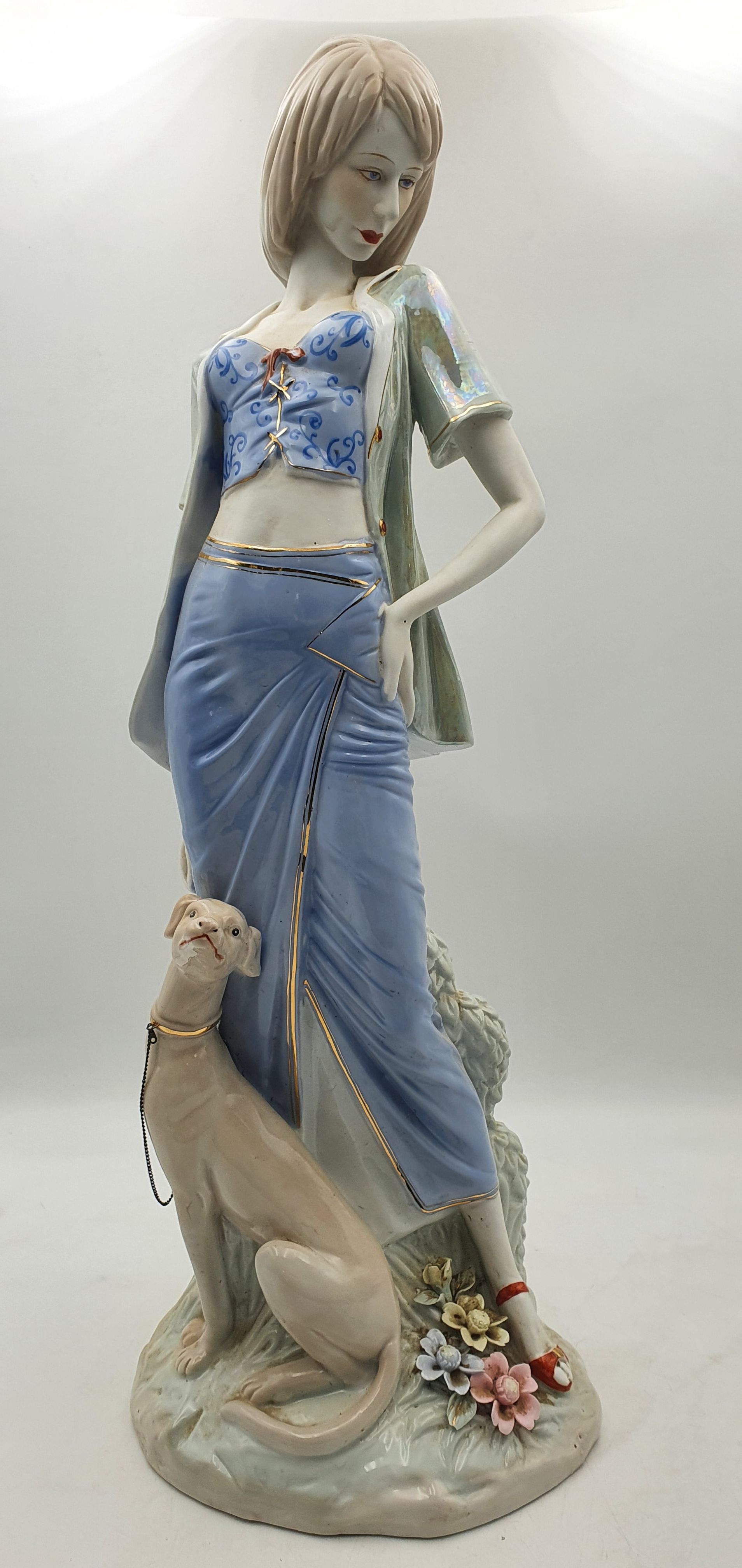 235 · A LARGE CERAMIC FIGURE OF A WOMAN AND GREYHOUND
