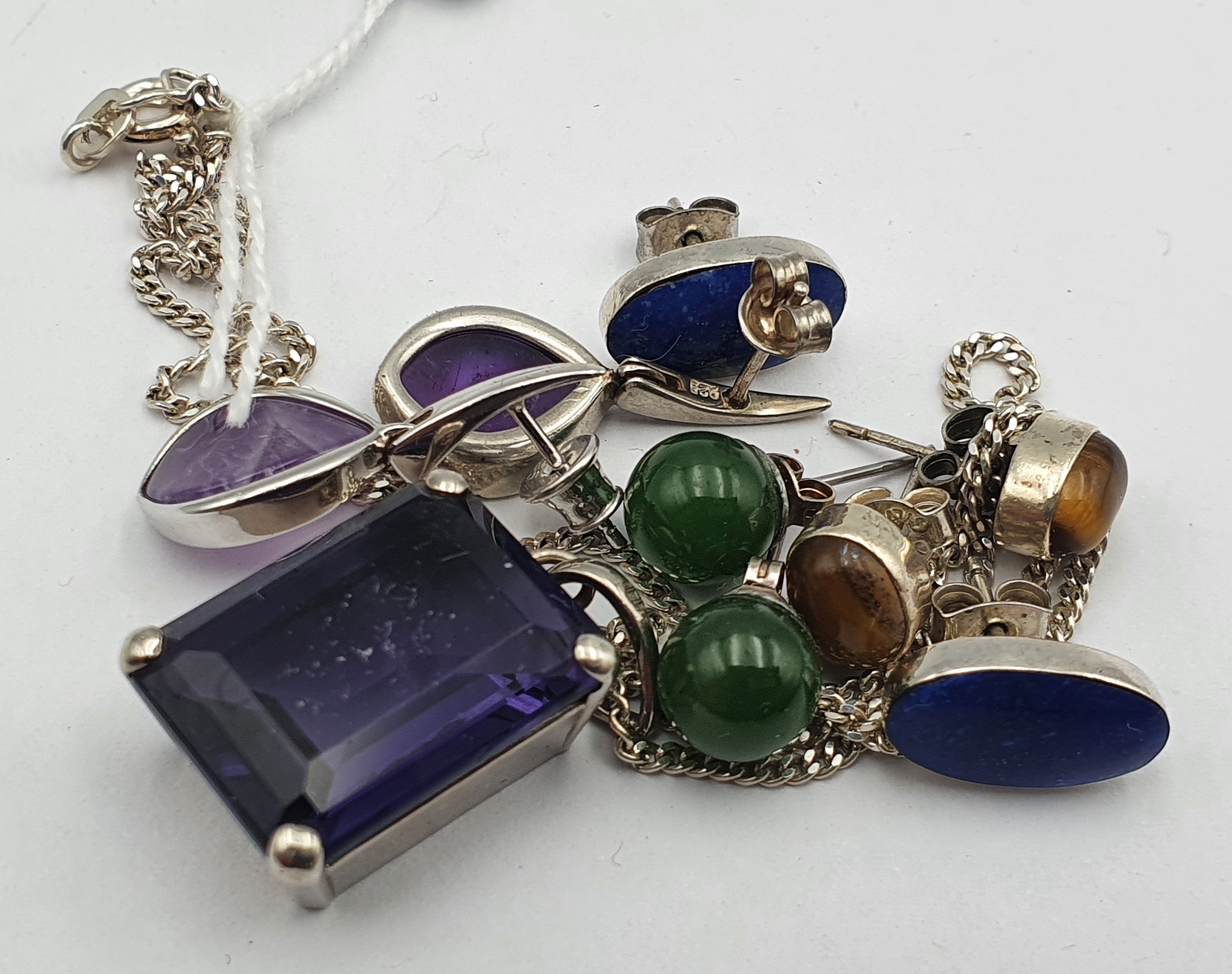 A Sterling Silver And Purple Paste Necklace And Four Pairs Of Silver And Gemstone-Set Earrings