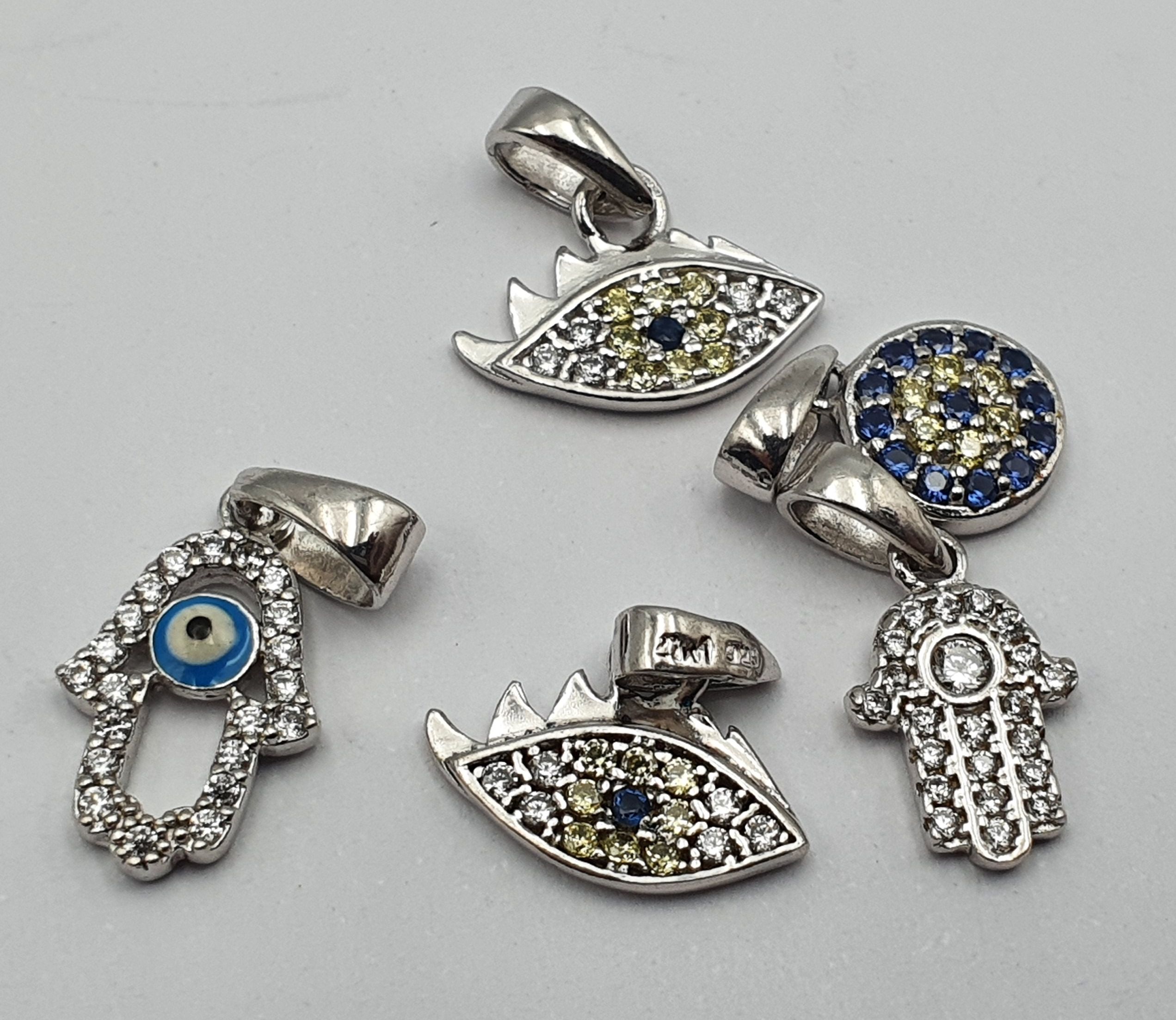 FIVE SILVER PENDANTS