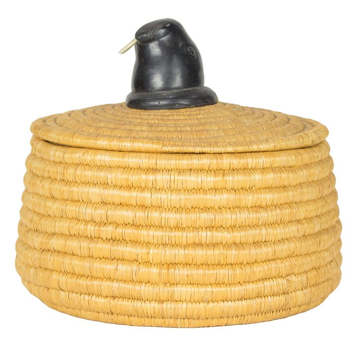 An Alaskan Inuit coil basket surmounted by a carved wood walrus head with tusks, 11"h x 11.5"d