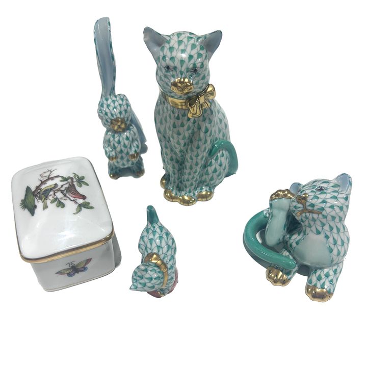 A group of Herend porcelain animals in a green net pattern